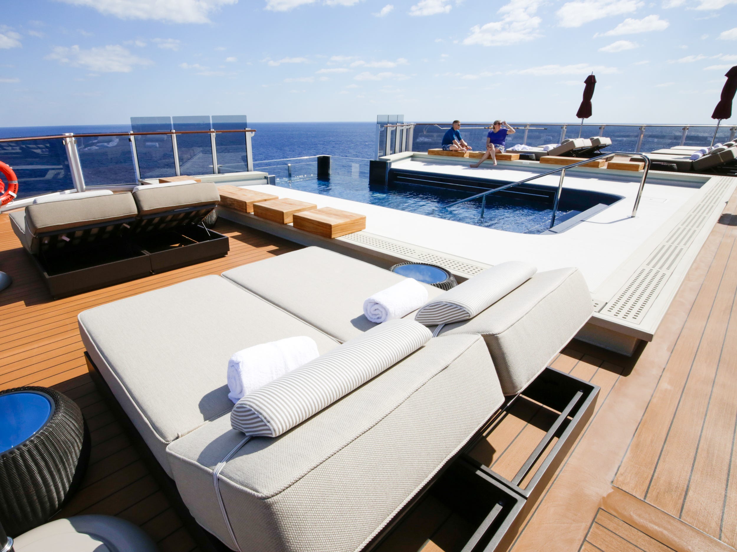 people at the Haven's outdoor pool deck on Norwegian Aqua