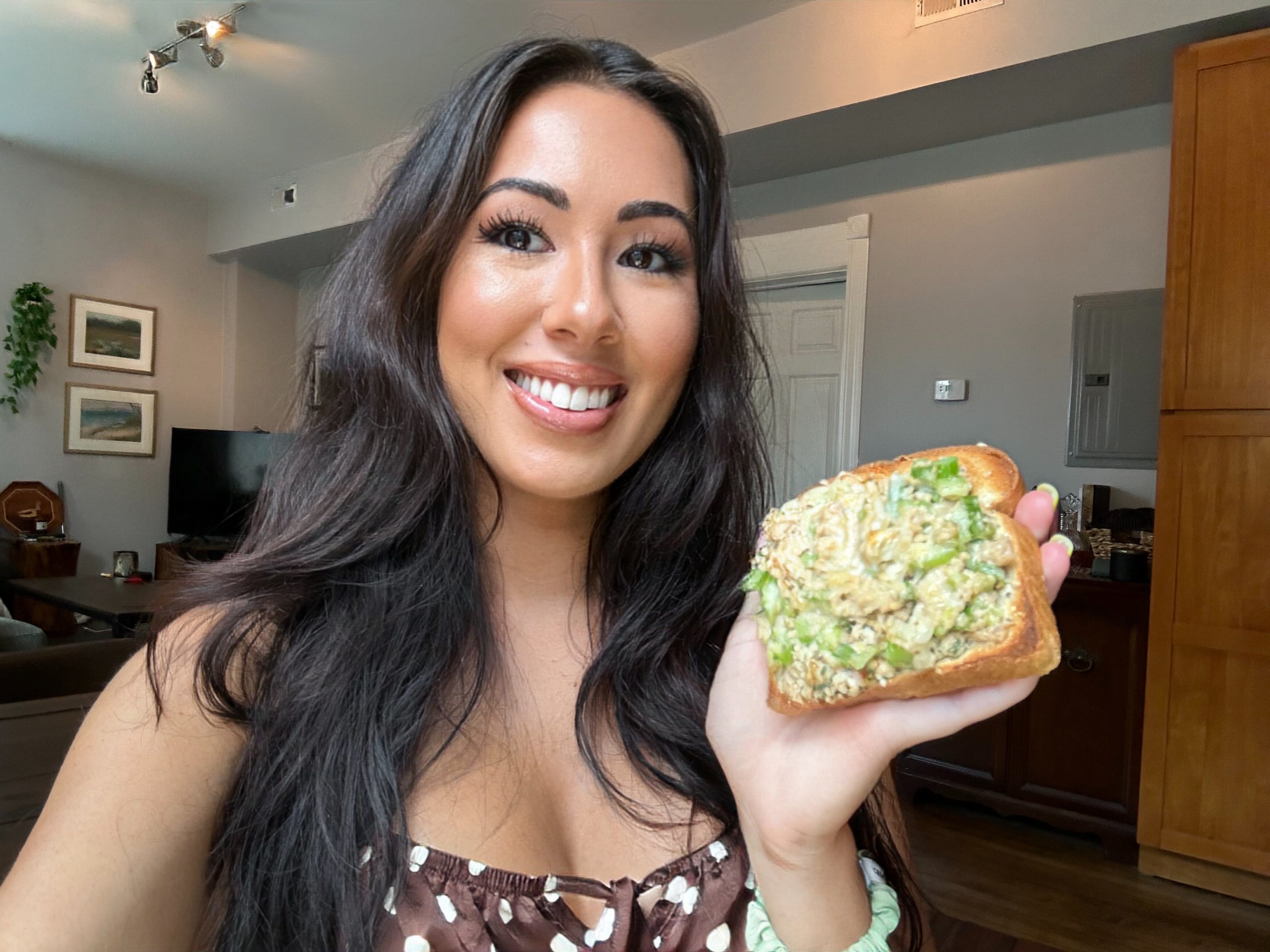 Lara taking a selfie holding a tuna-met made from Ina Garten's recipe.