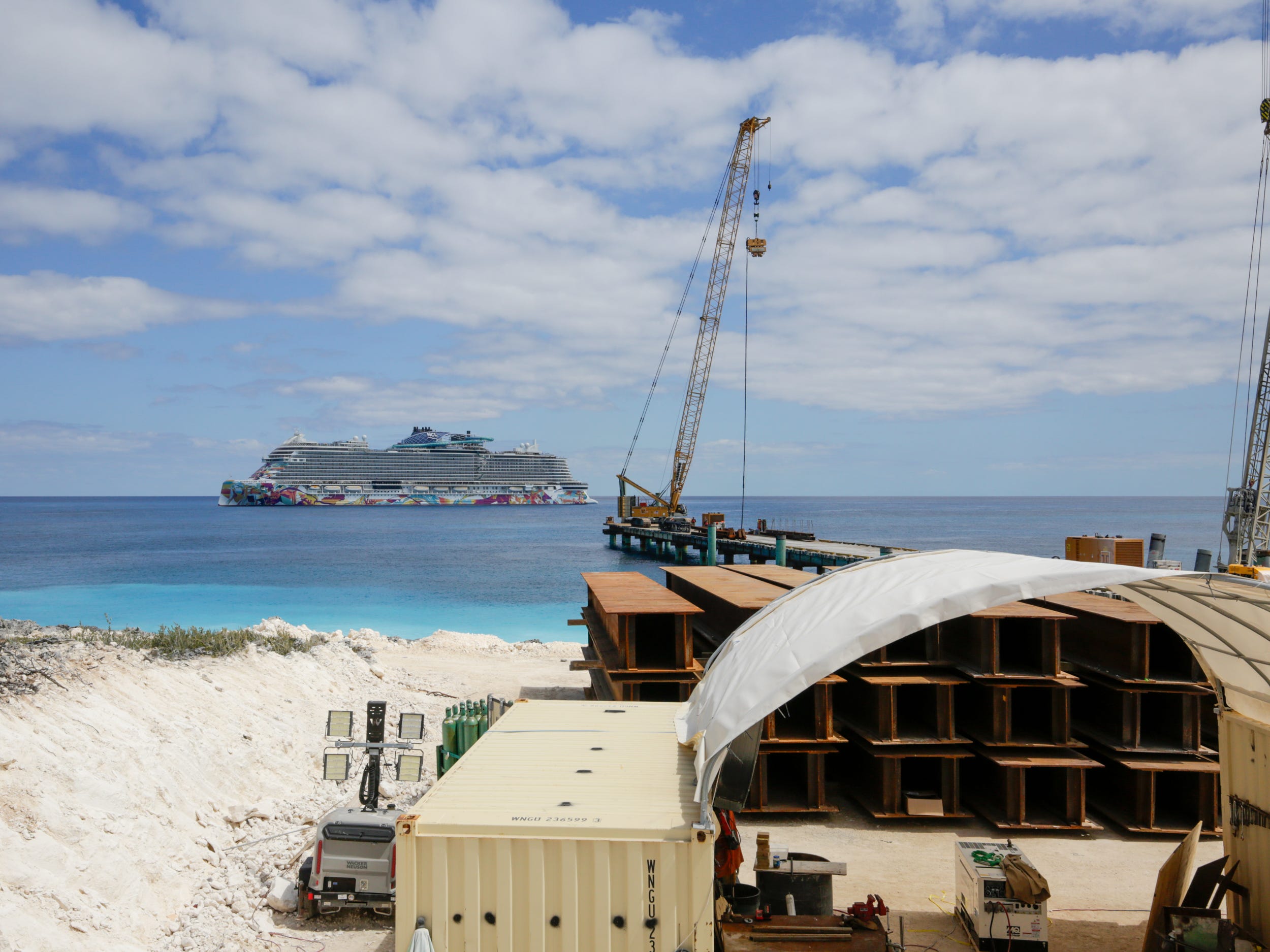 a norwegian cruise ship docked near the construction of a pier at Great Stirrup Cay