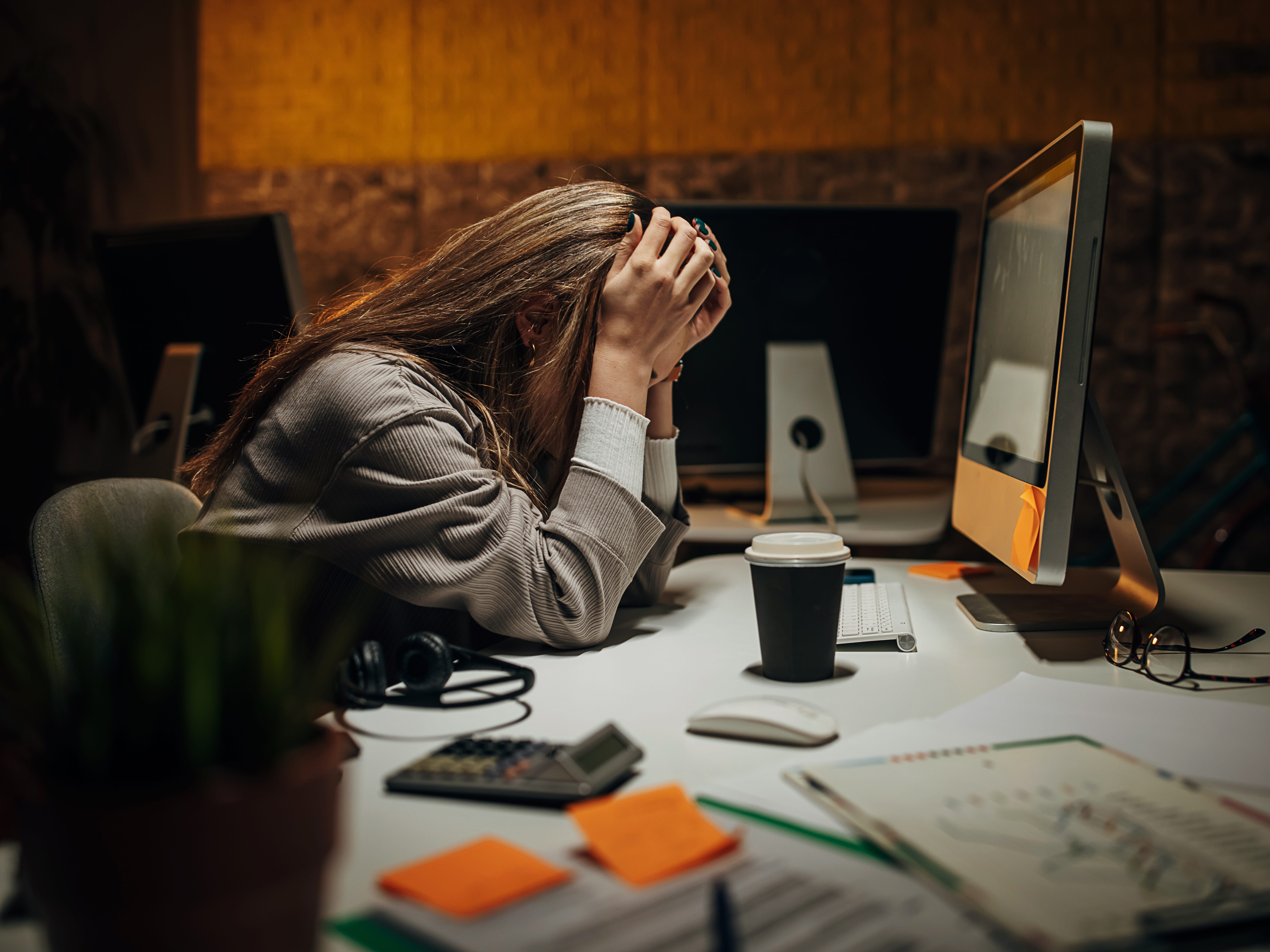 a woman frustrated at her work desk