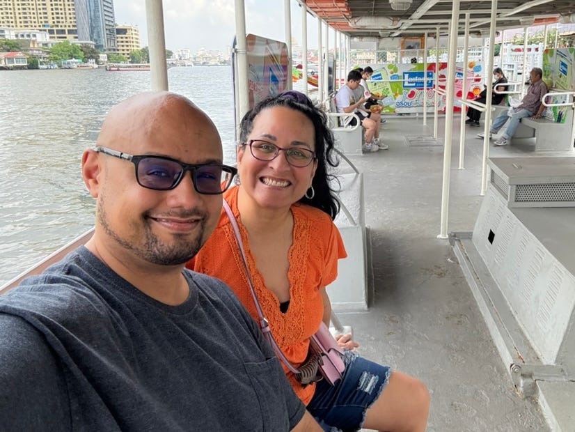 Kimanzi Constable and his wife on a boat in thailand