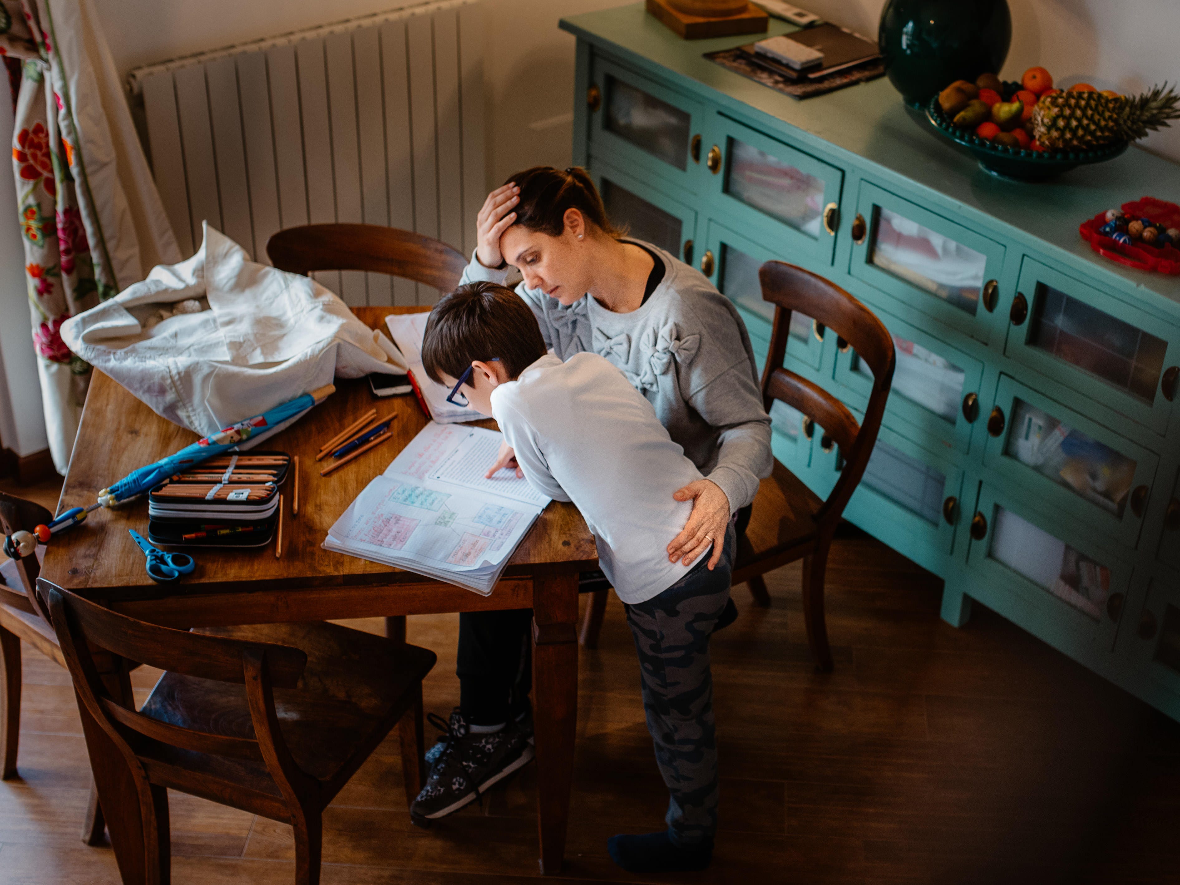 Mother and son are doing school work together