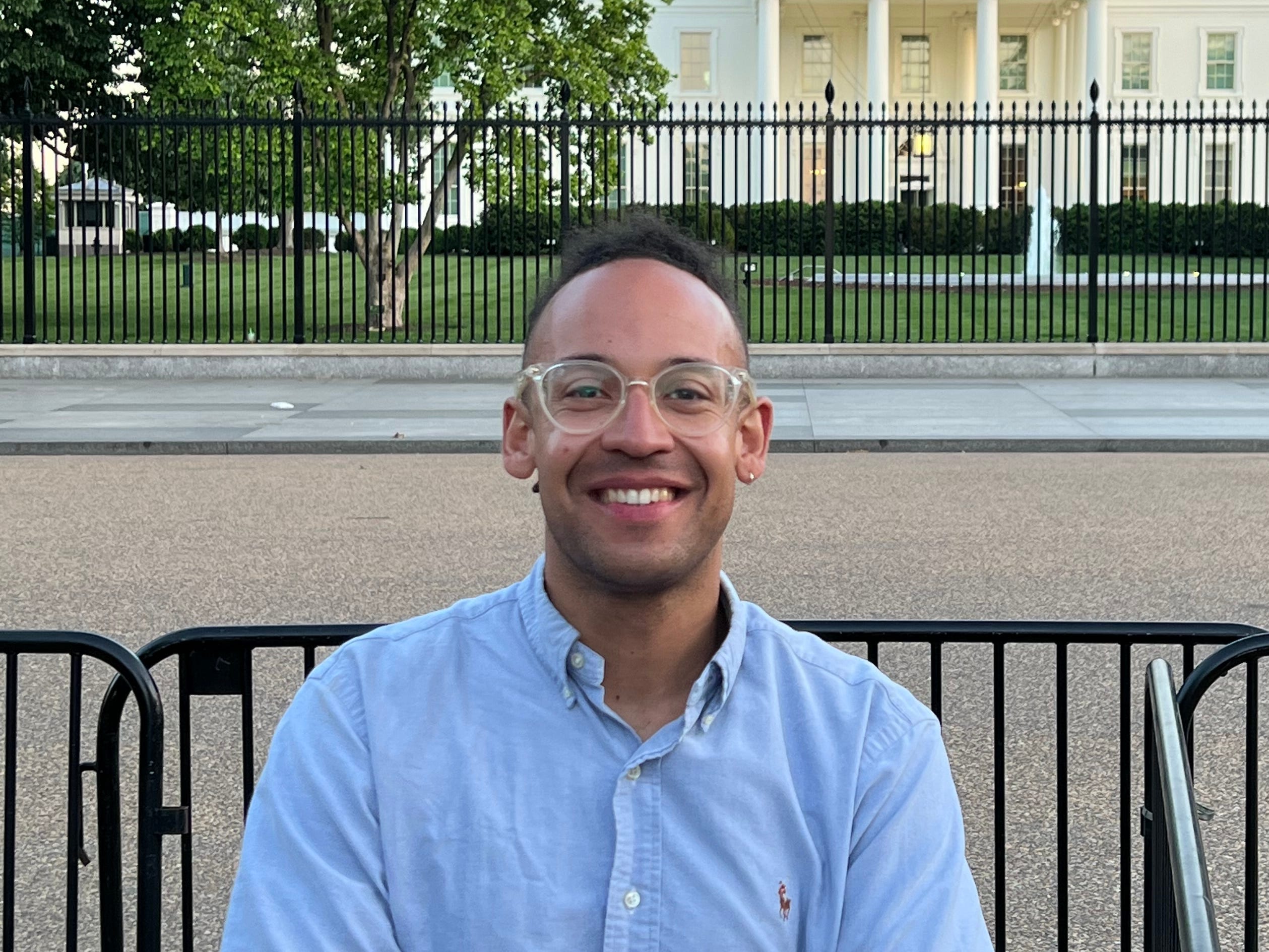 man poses for a photo in front of the White House