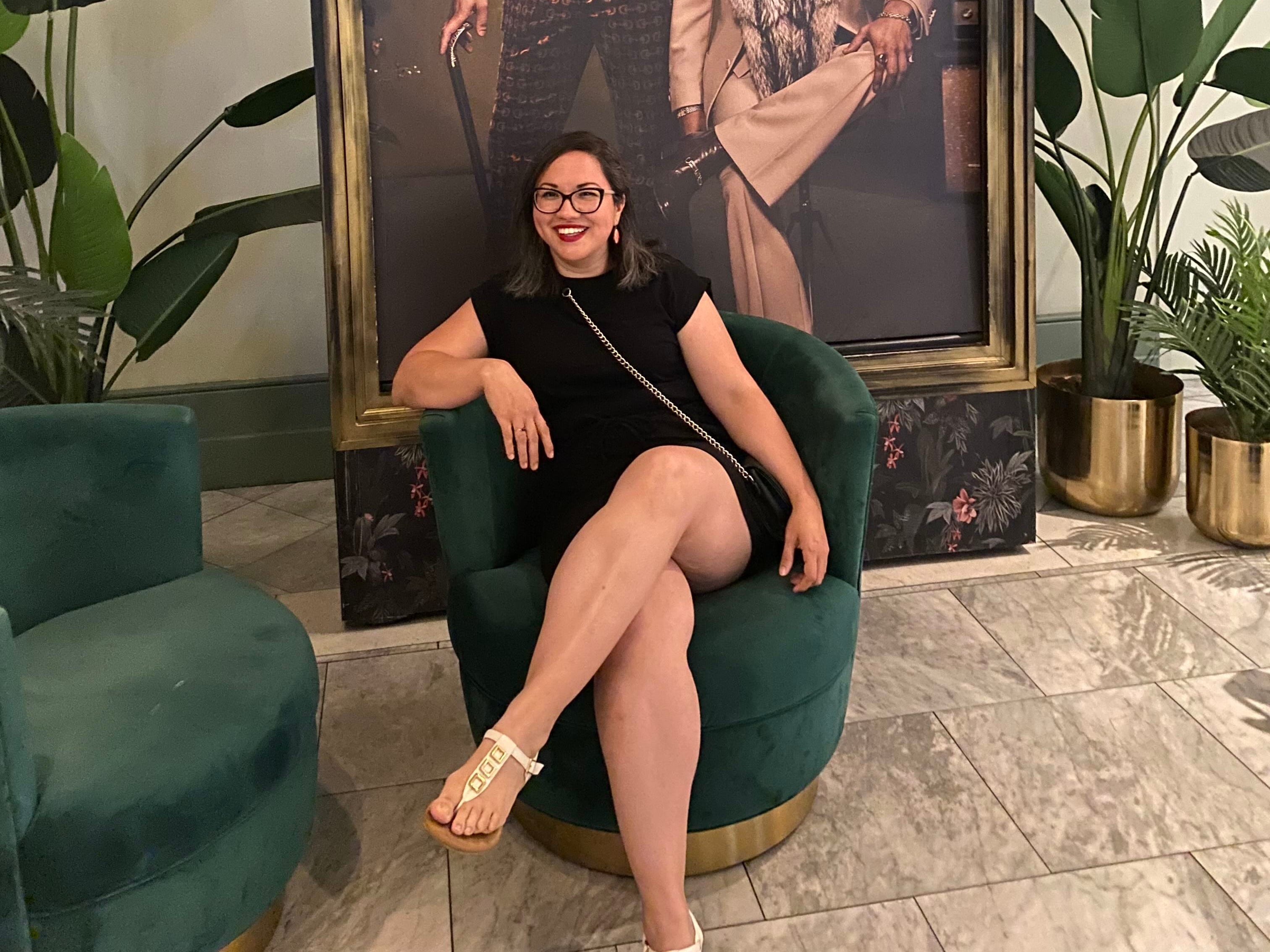 Priscilla Blossom sitting on a green sofa chair in Las Vegas.