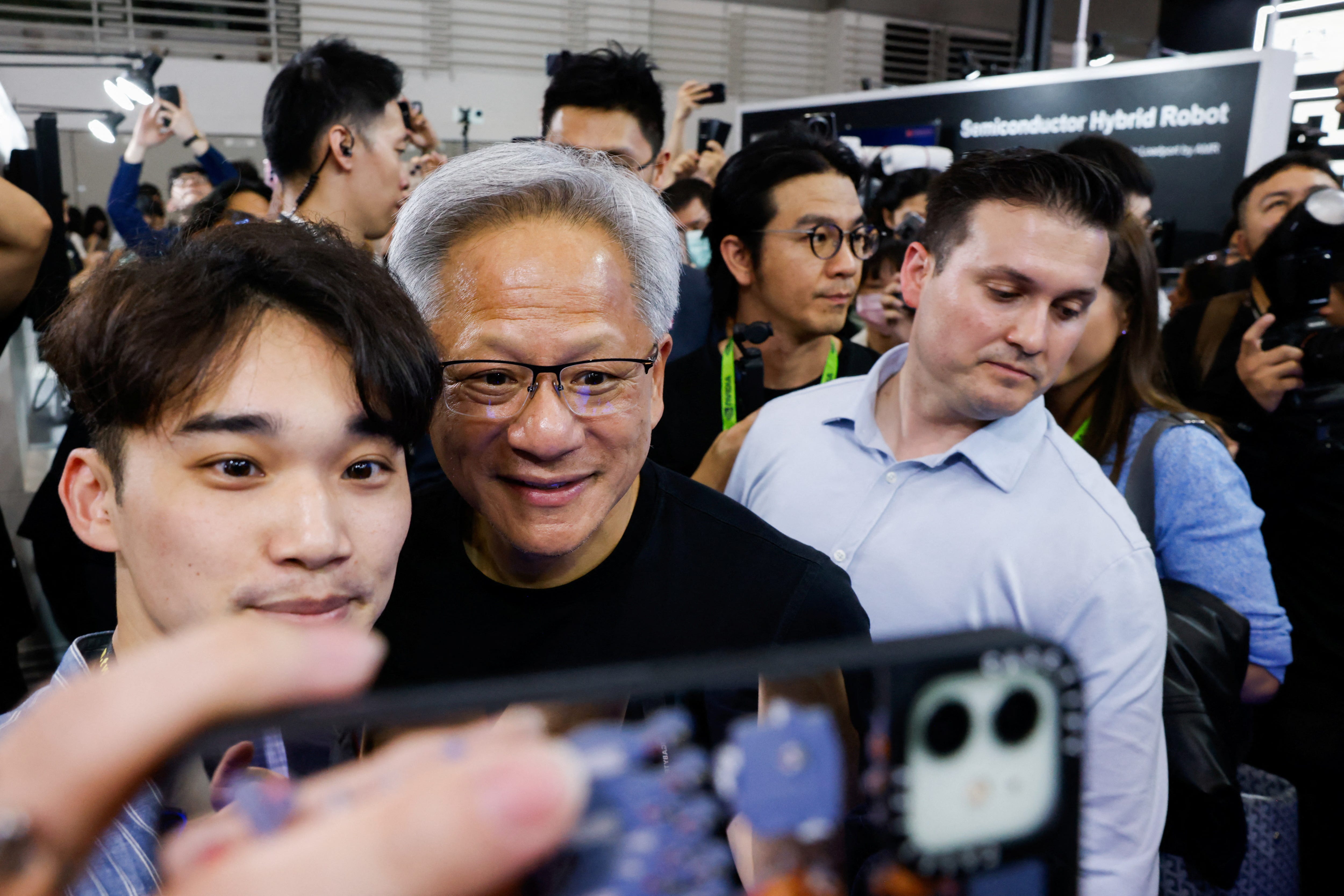Nvidia's CEO Jensen Huang poses for a photo with a supporter at Computex Taipei.