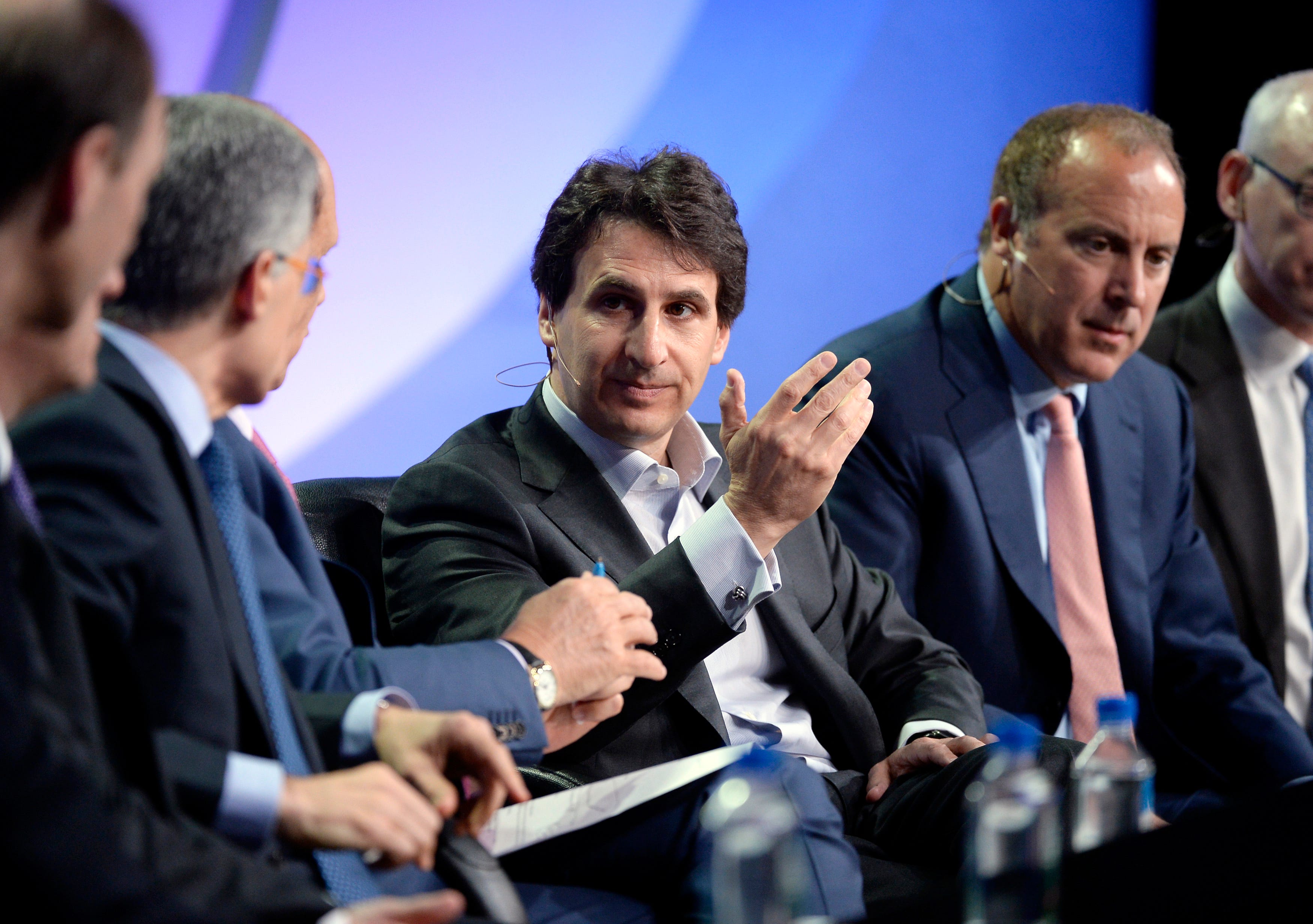 Marc Rowan between other speakers on a panel.