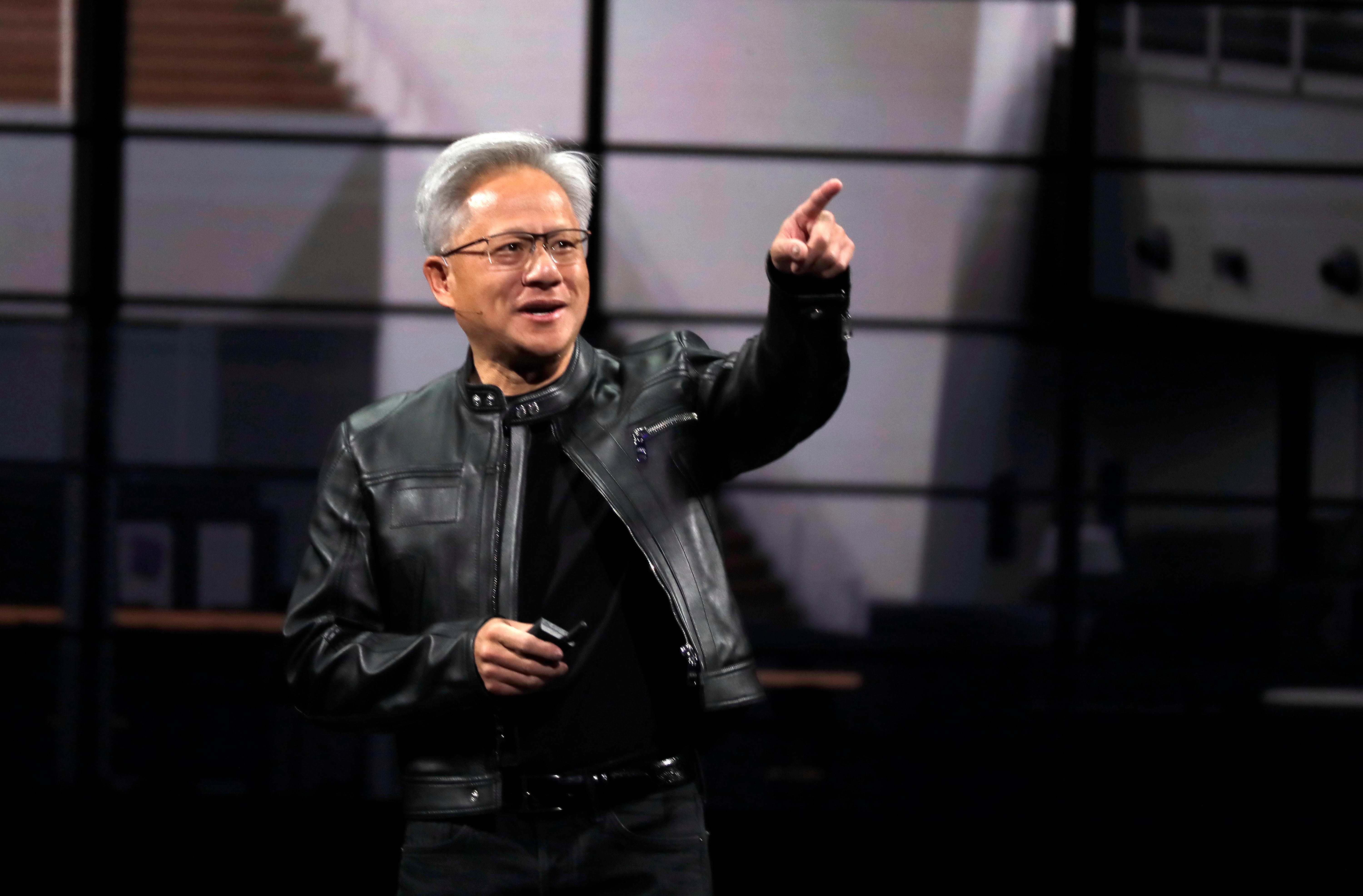 Jensen Huang on stage with black leather jacket in May 2025