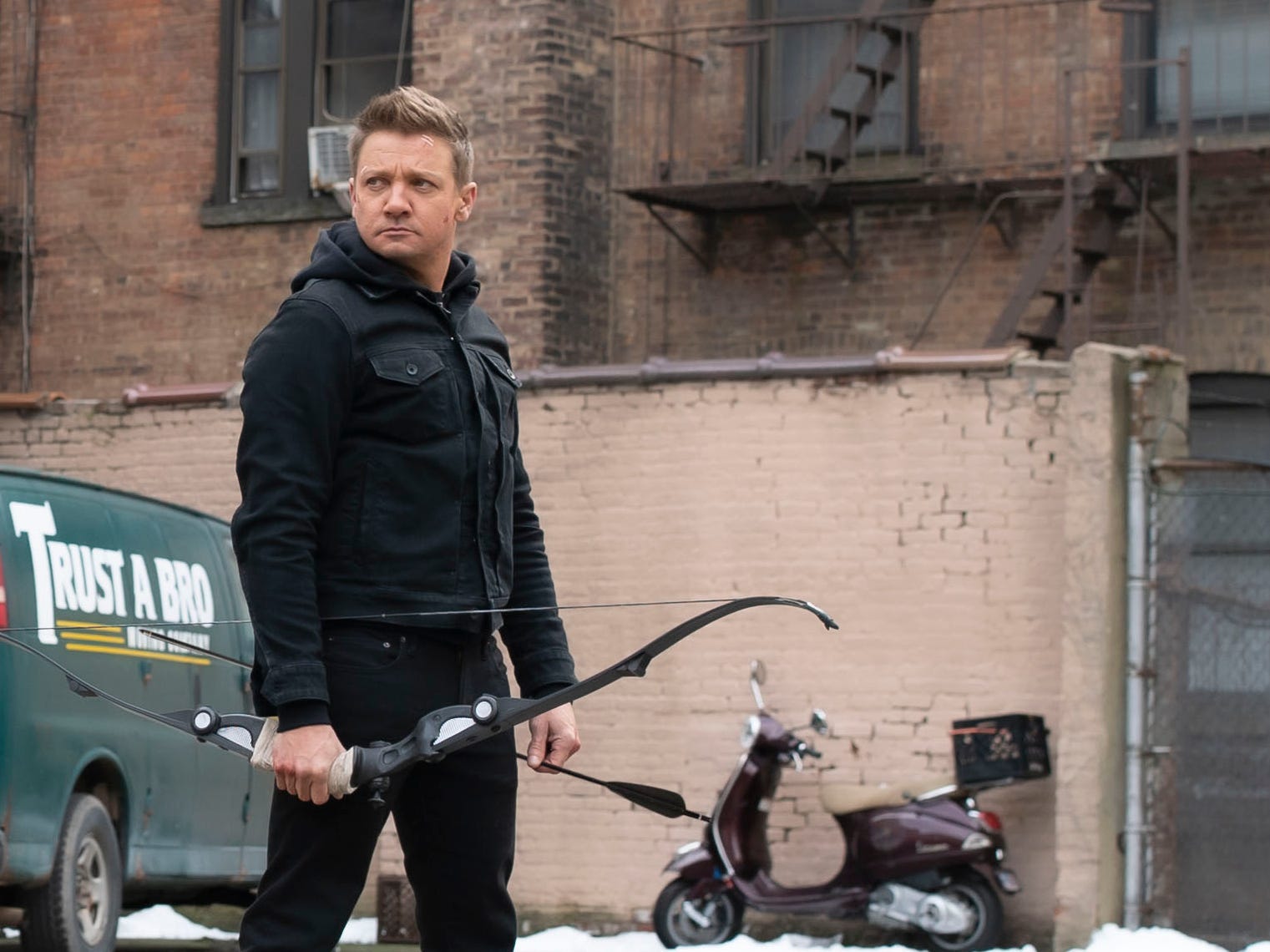 Jeremy Renner holding a bow and arrow on "Hawkeye."