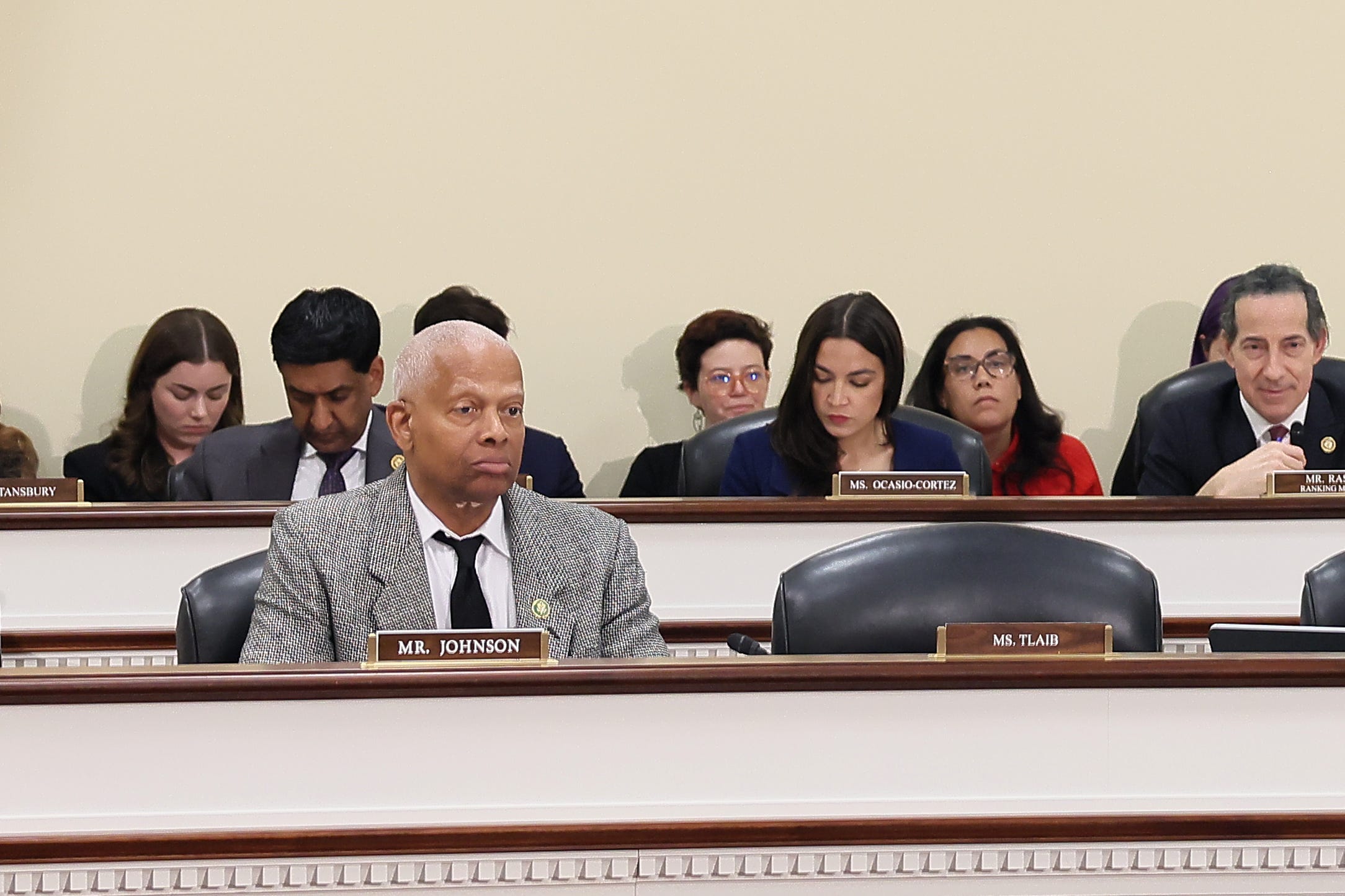 Members of Congress sitting behind the dais in a hearing room.