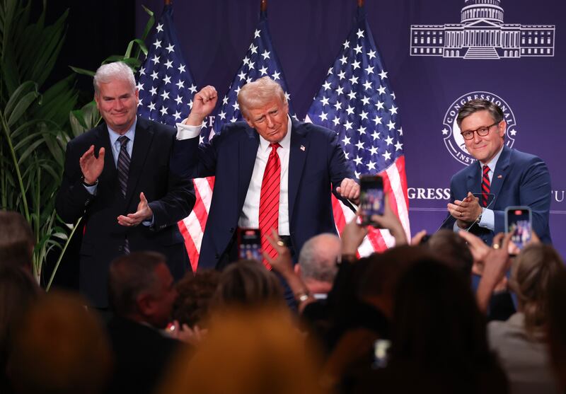 Trump dances as Tom Emmer and Mike Johnson look on.