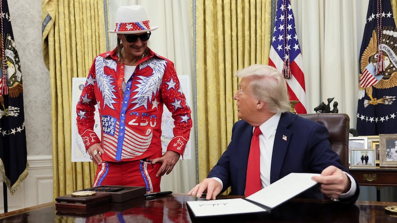 U.S. President Donald Trump speaks with Kid Rock in the Oval Office.