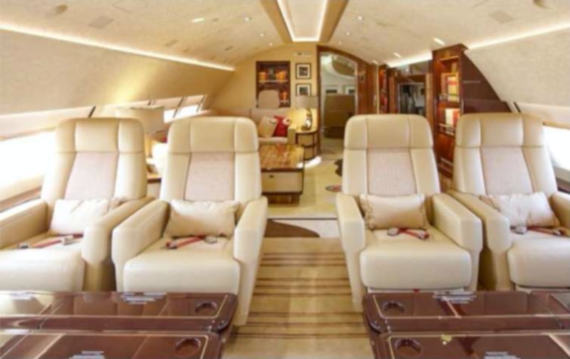 Double seats in the upper deck, with a living room just beyond.