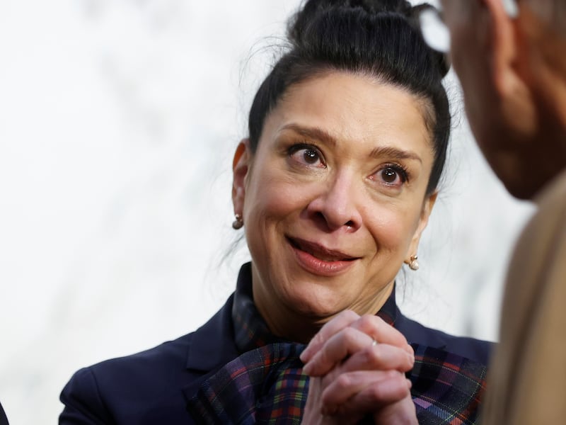 U.S. District Judge Esther Salas speaks with tears in her eyes and her hands clasped out in front of her.