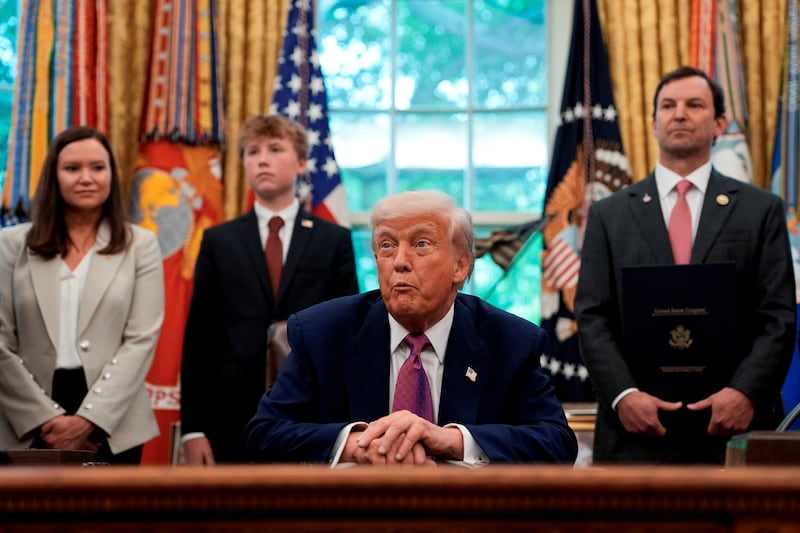 U.S. Senator Ashley Moody (R-FL) and U.S. Representative Craig Goldman (R-TX) stand behind U.S. President Donald Trump in the Oval Office of the White House, in Washington, D.C., U.S., May 9, 2025. REUTERS/Kent Nishimura