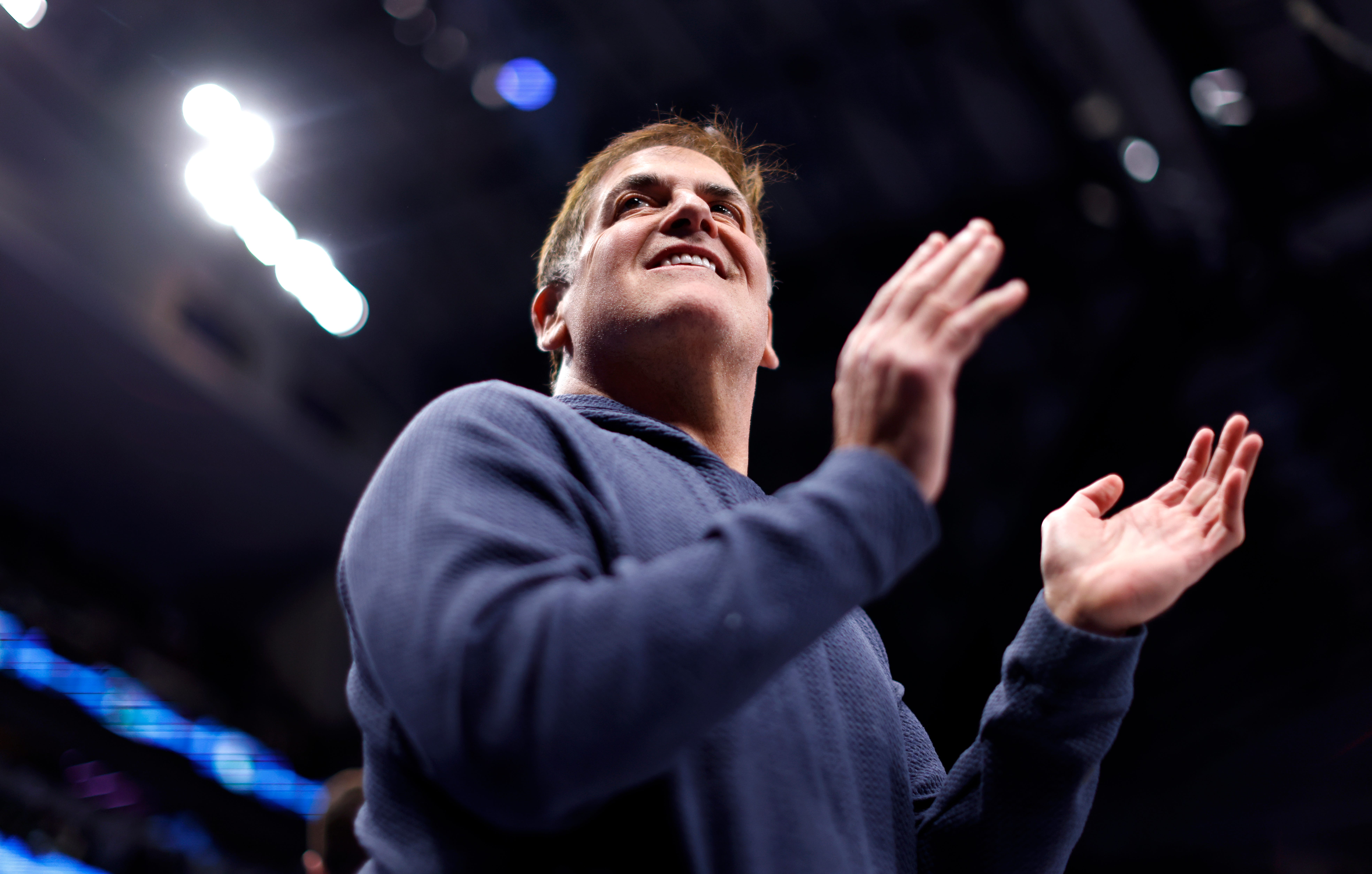 Mark Cuban clapping his hands and cheering at American Airlines Center in Dallas, Texas.