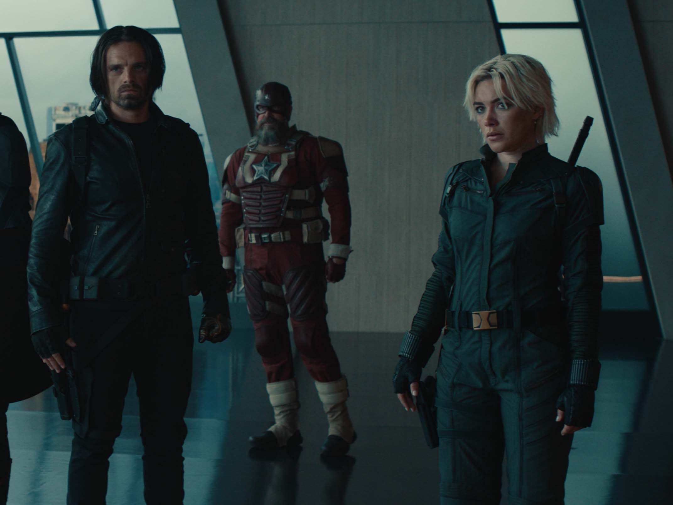 A still of "Thuhderbolts*" showing a group of people in superhero outfits.