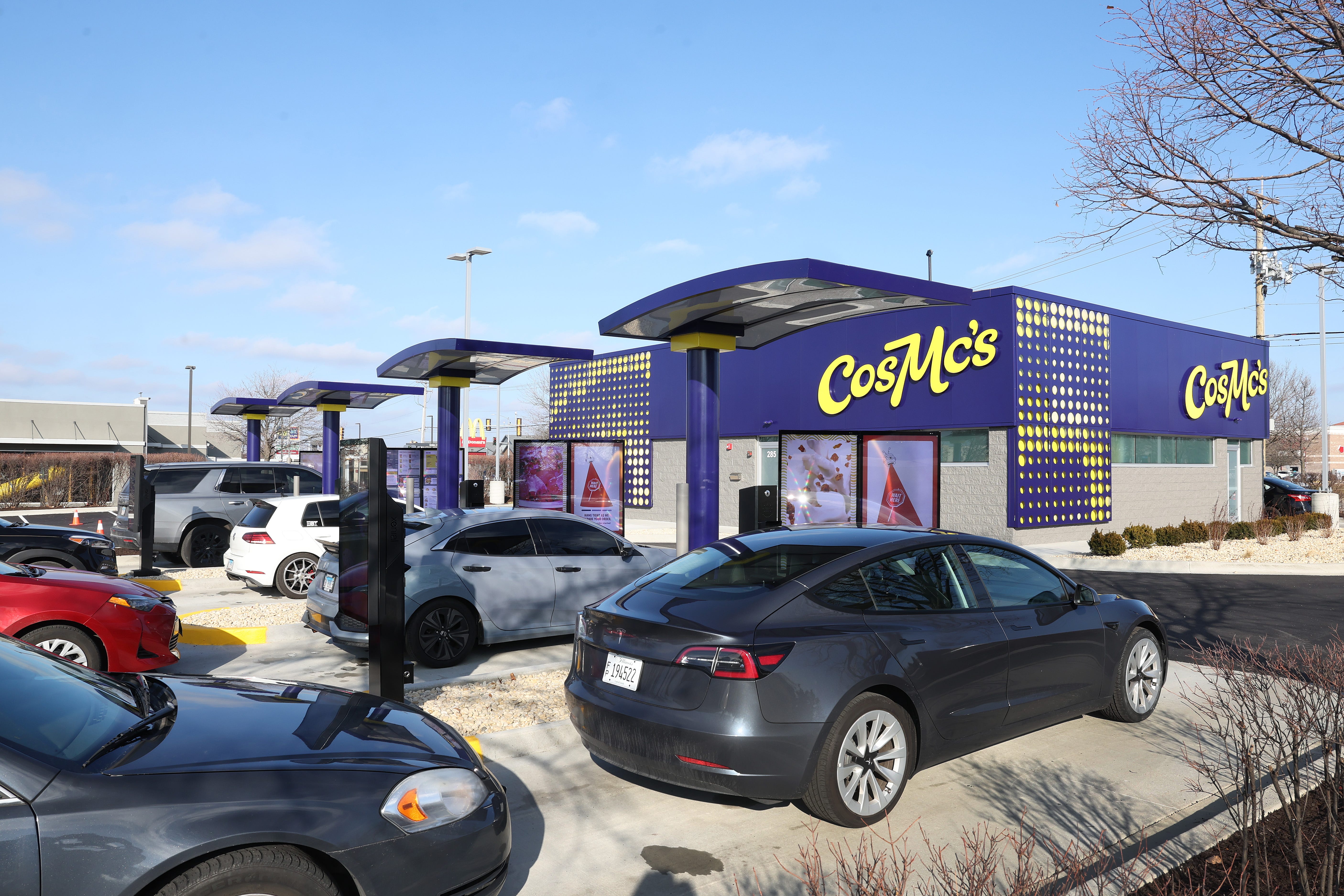 Cars lined up outside of a CosMc's location.