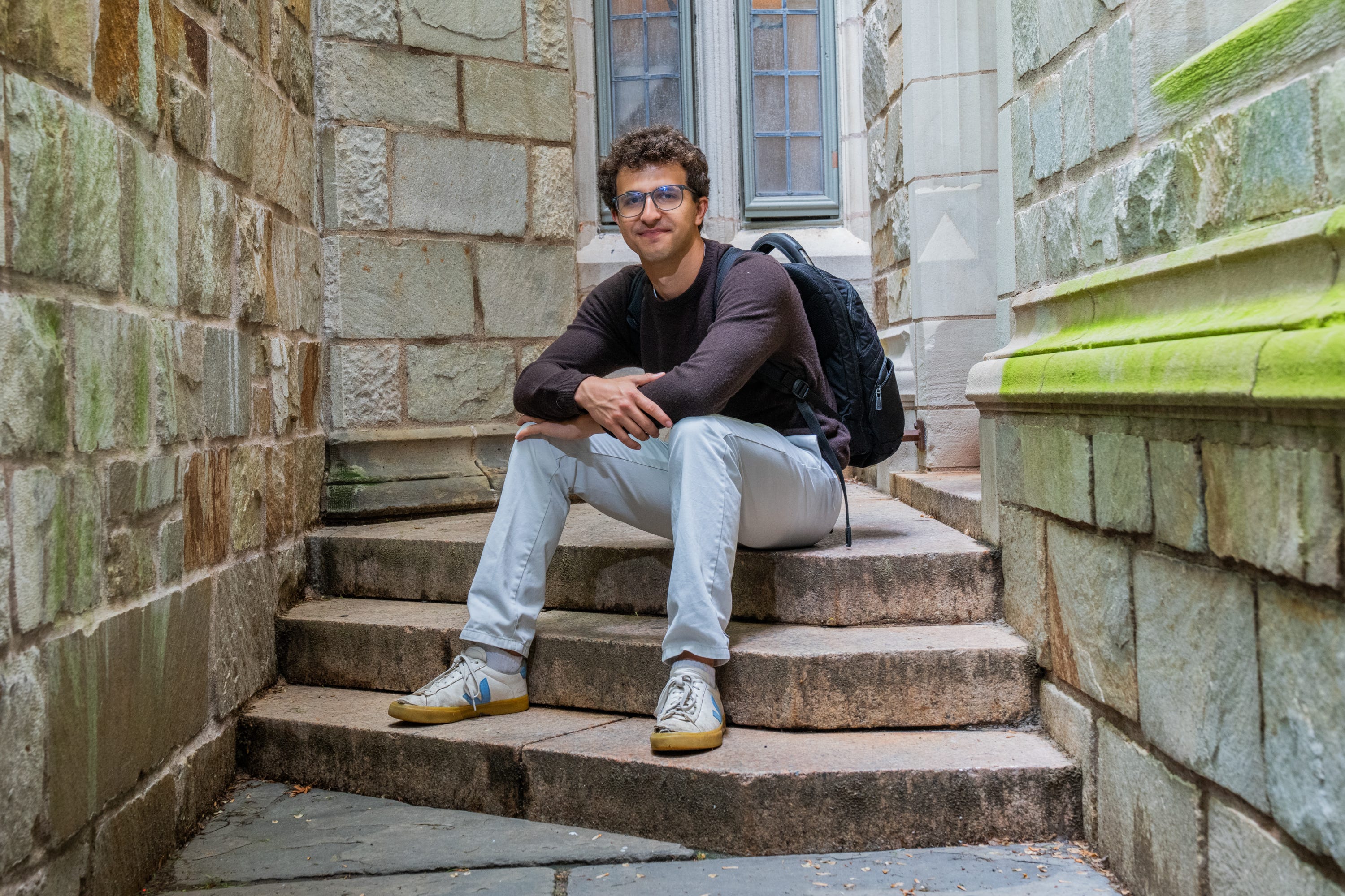Alex Schapiro is sitting on the stair landing