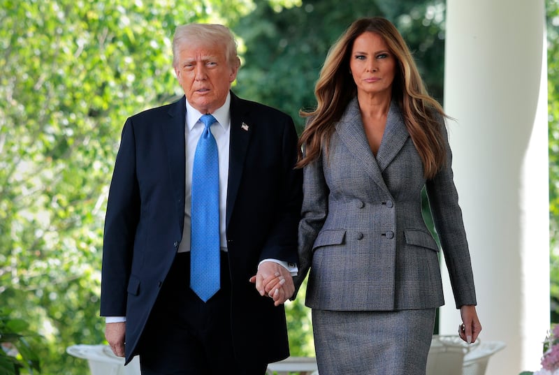 WASHINGTON, DC - MAY 19: U.S. President Donald Trump and first lady Melania Trump arrive at the signing ceremony for the TAKE IT DOWN Act in the Rose Garden of the White House on May 19, 2025 in Washington, DC. The first lady made the Tools to Address Known Exploitation by Immobilizing Technological Deepfakes on Websites and Networks (TAKE IT DOWN) Act a priority, traveling to Capitol Hill to lobby lawmakers and show her support for the legislation, which addresses non-consensual intimate imagery, or "revenge porn," and artificial intelligence deepfakes posted online and to social media. (Photo by Chip Somodevilla/Getty Images)