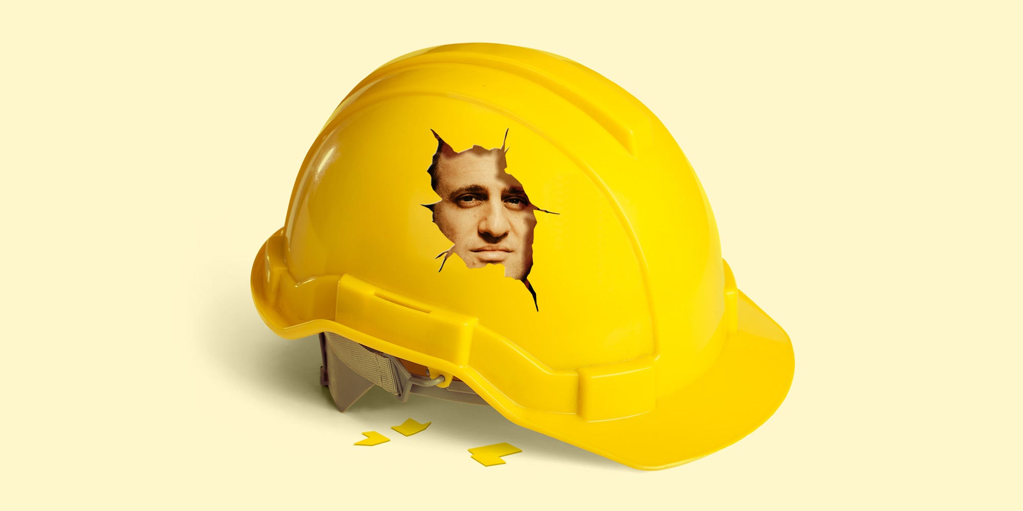 Michael Stern's face peeks out through a crack in a yellow hard hat.
