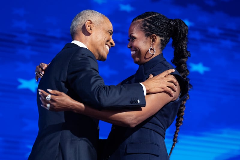 Former President Barack Obama and former First Lady Michelle Obama appear on stage at the Democratic National Convention last year.