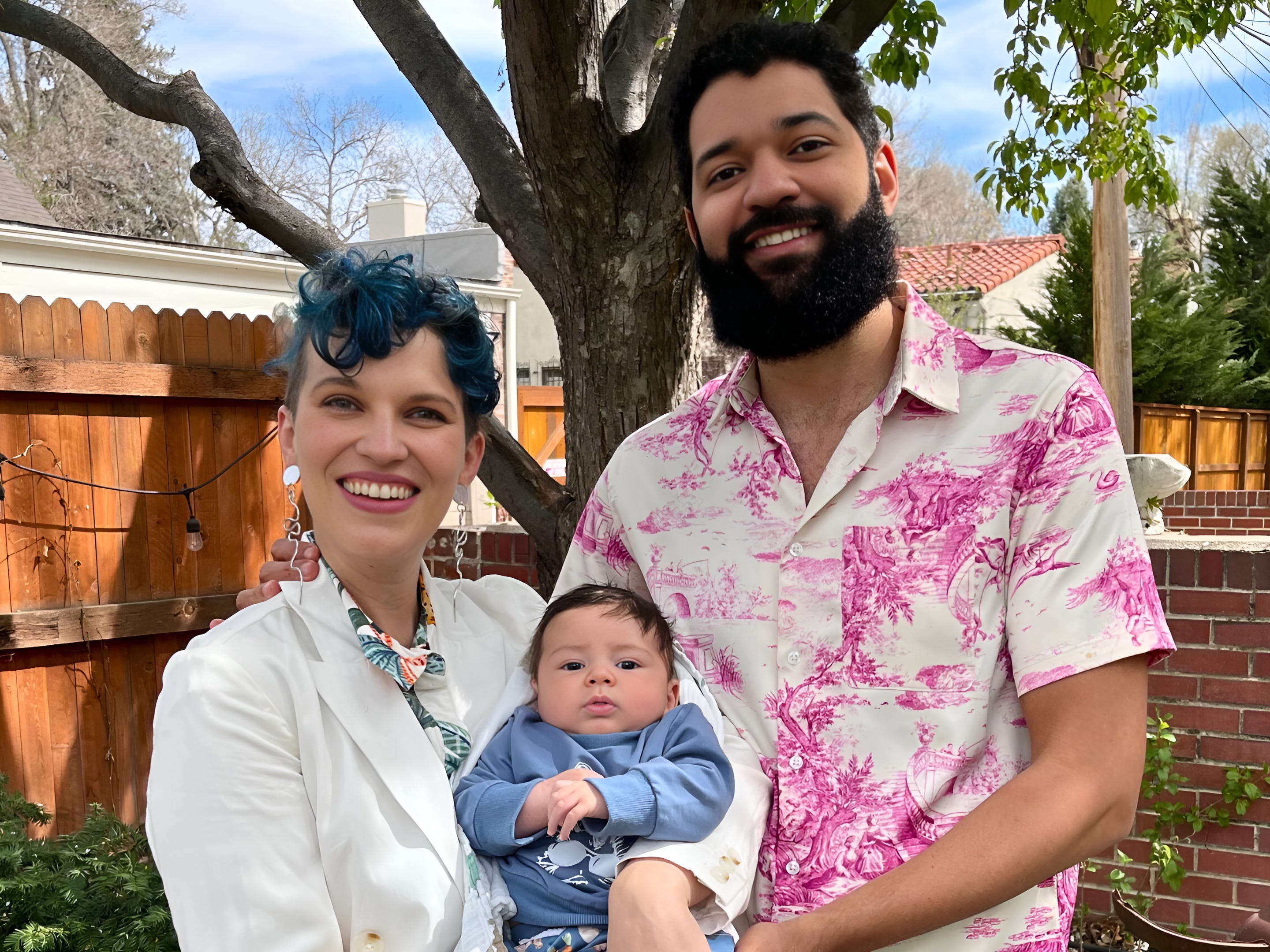 The author and her husband standing outside with their son.