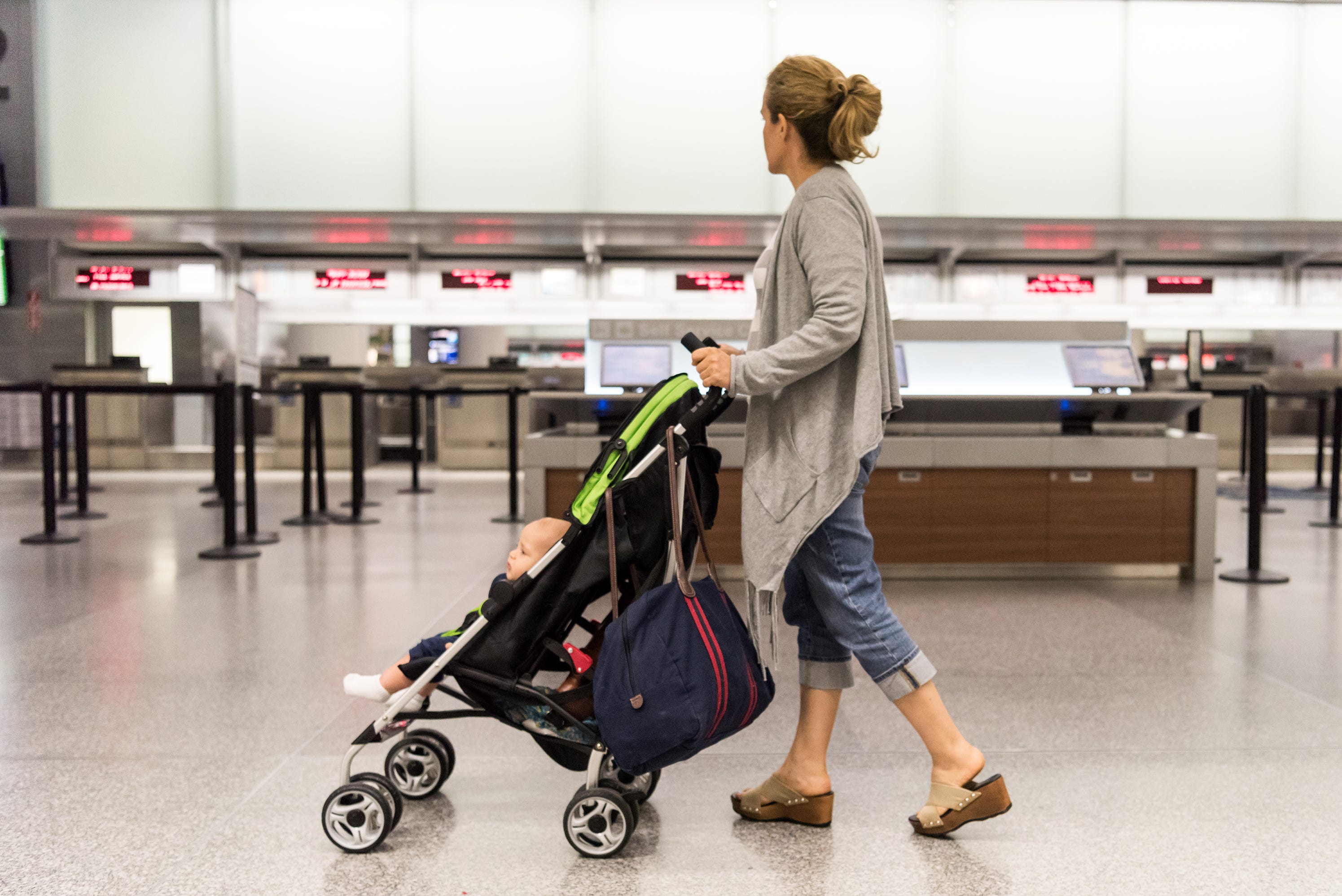 Women with a stroller and a baby at the airport
