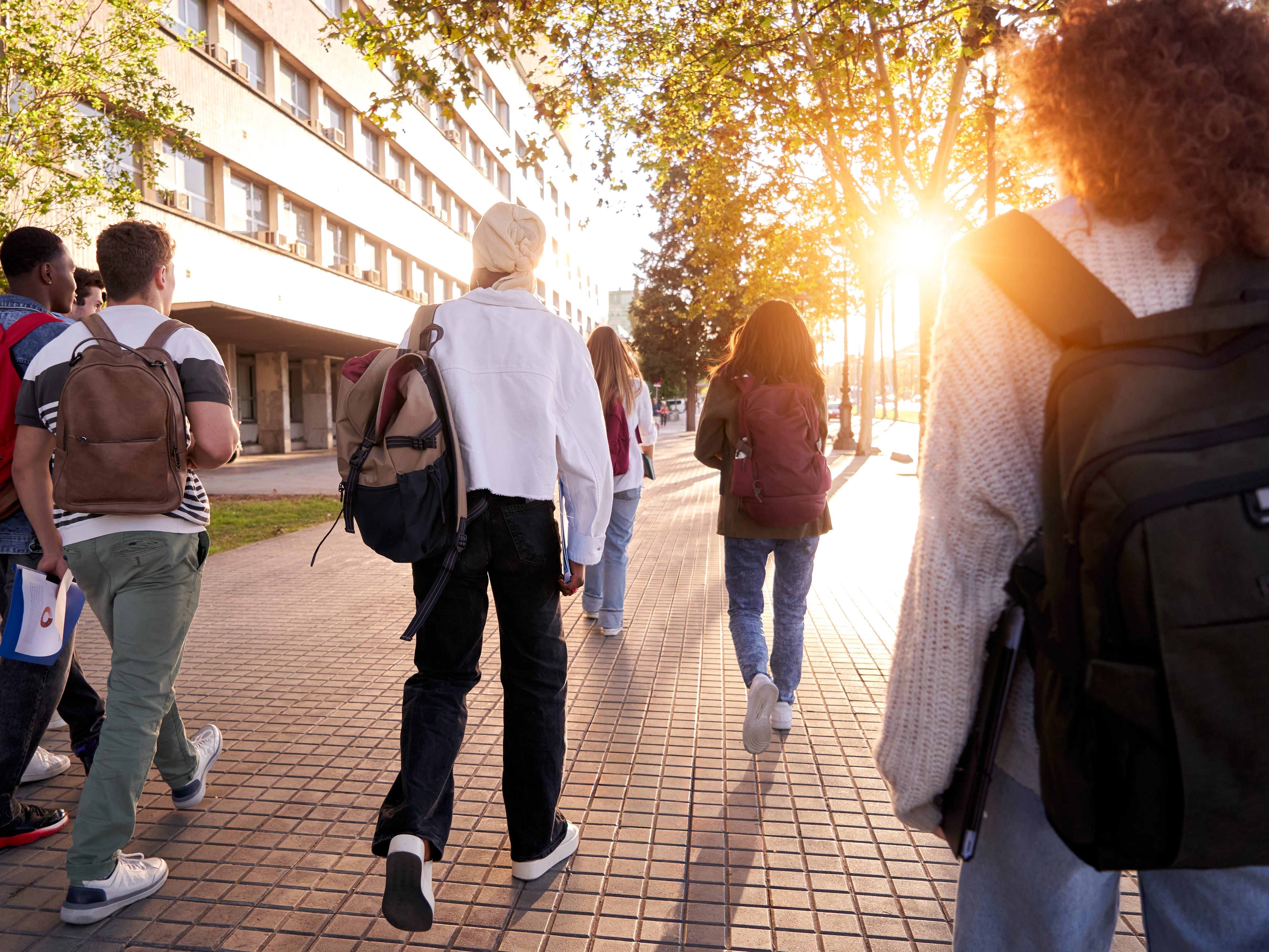 the back of students ealking away on campus