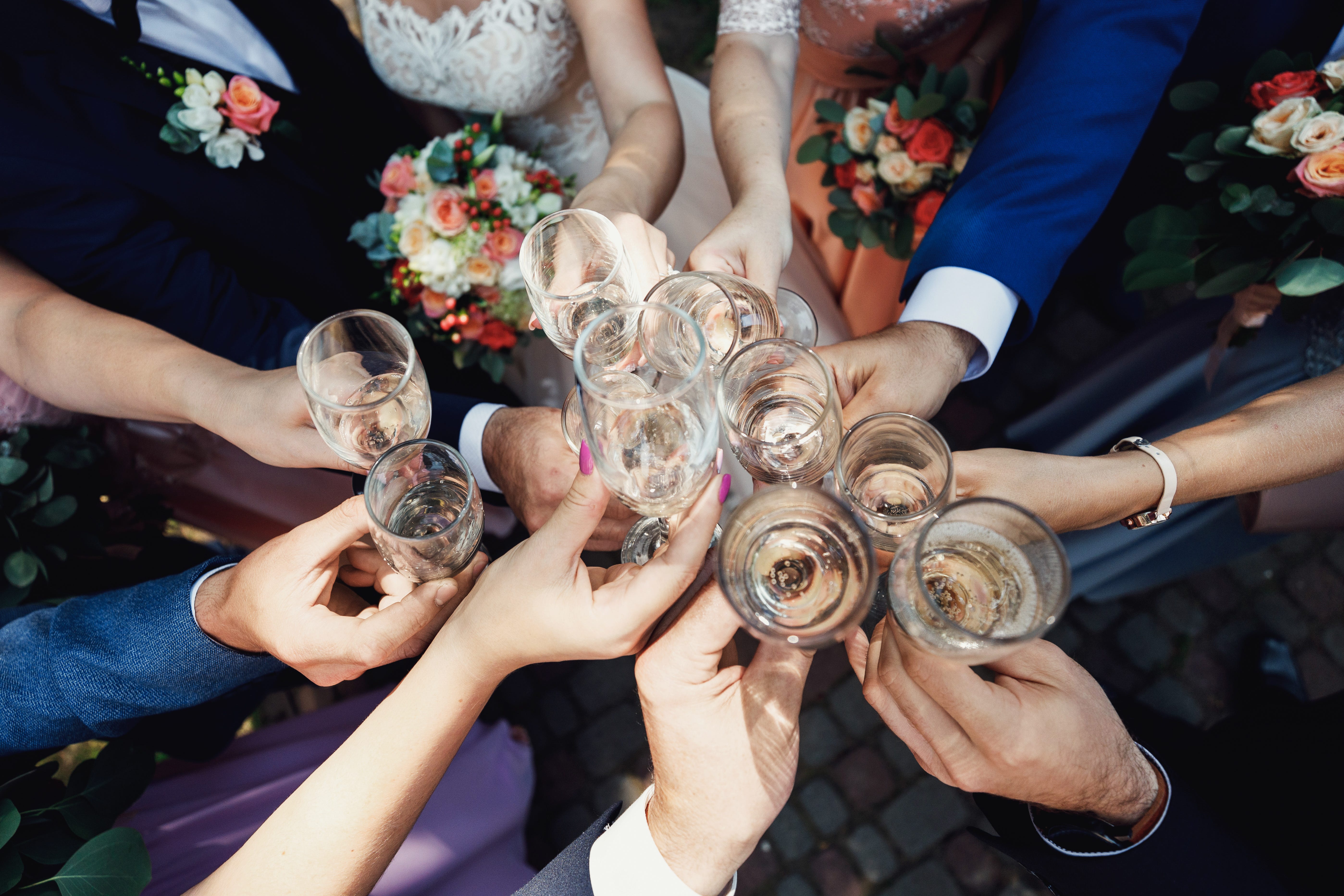 Hands holding champagne glasses, cheersing