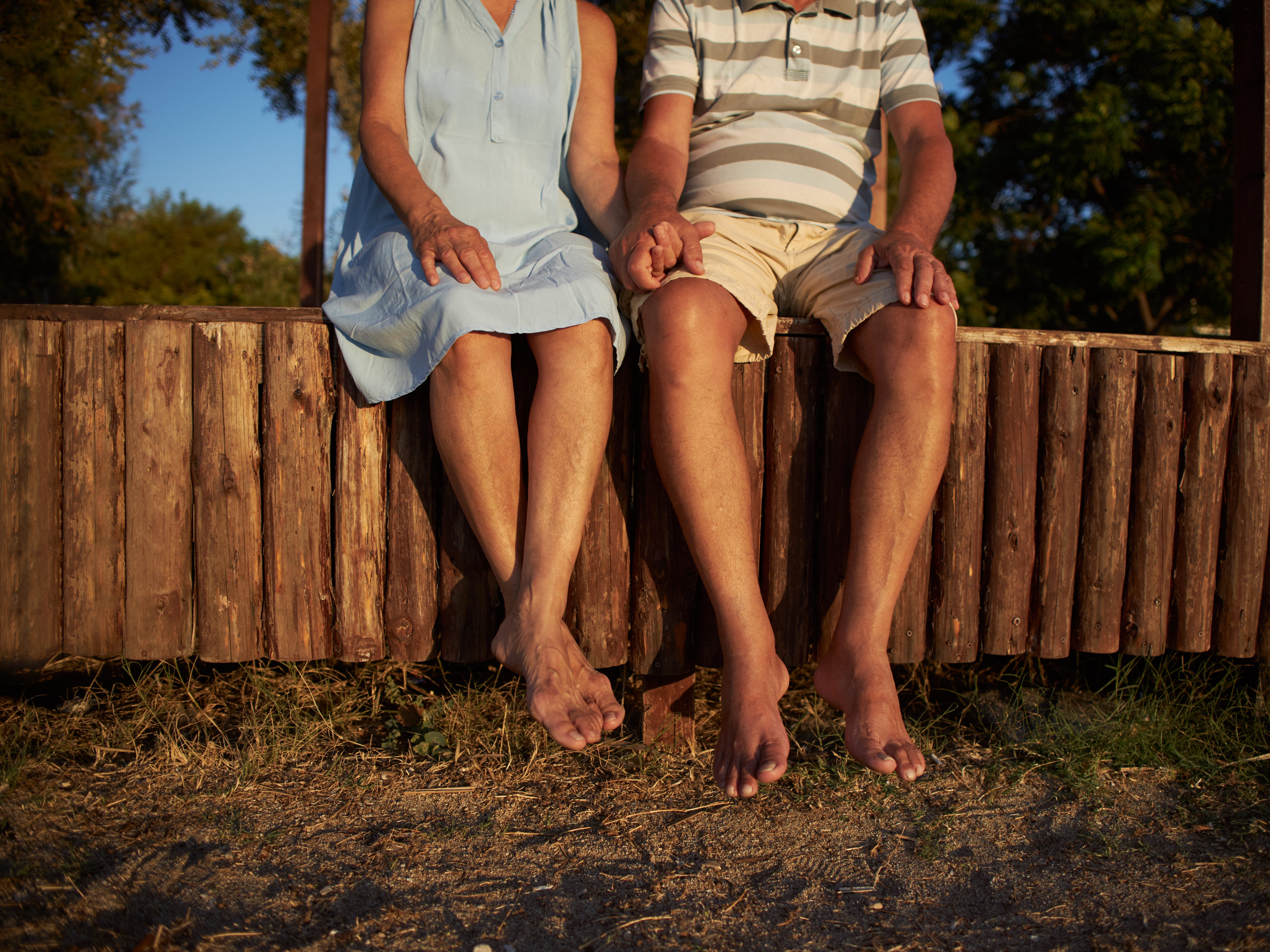 Close-up of legs of senior couple enjoying summer vacation