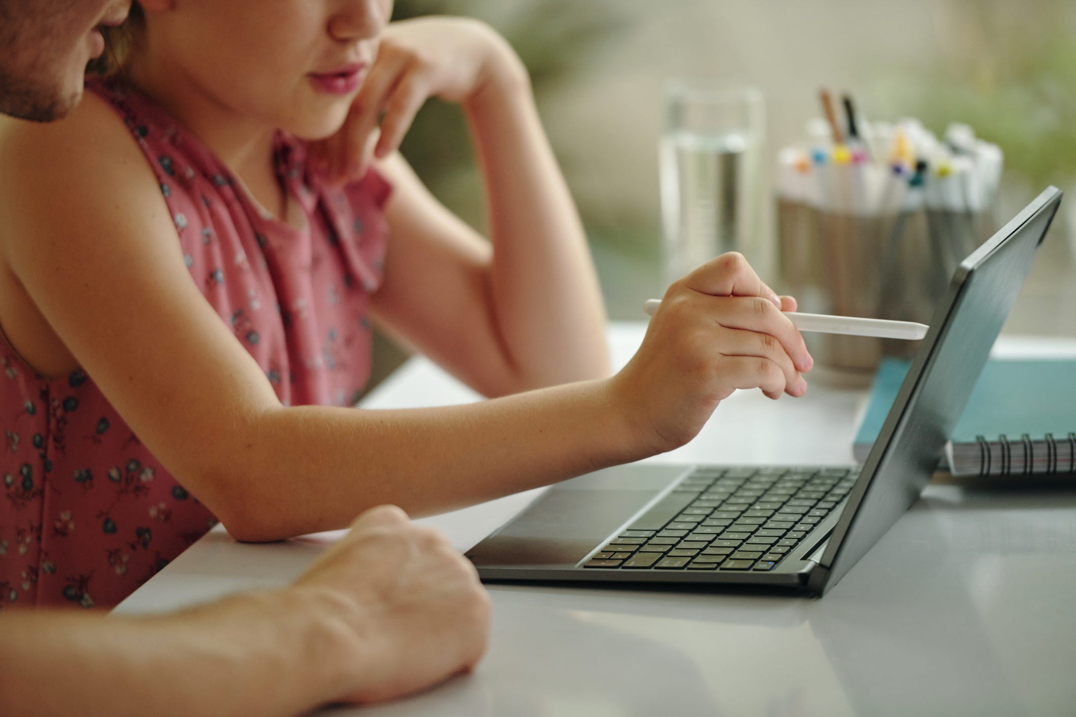 A parent and their child working on a laptop computer
