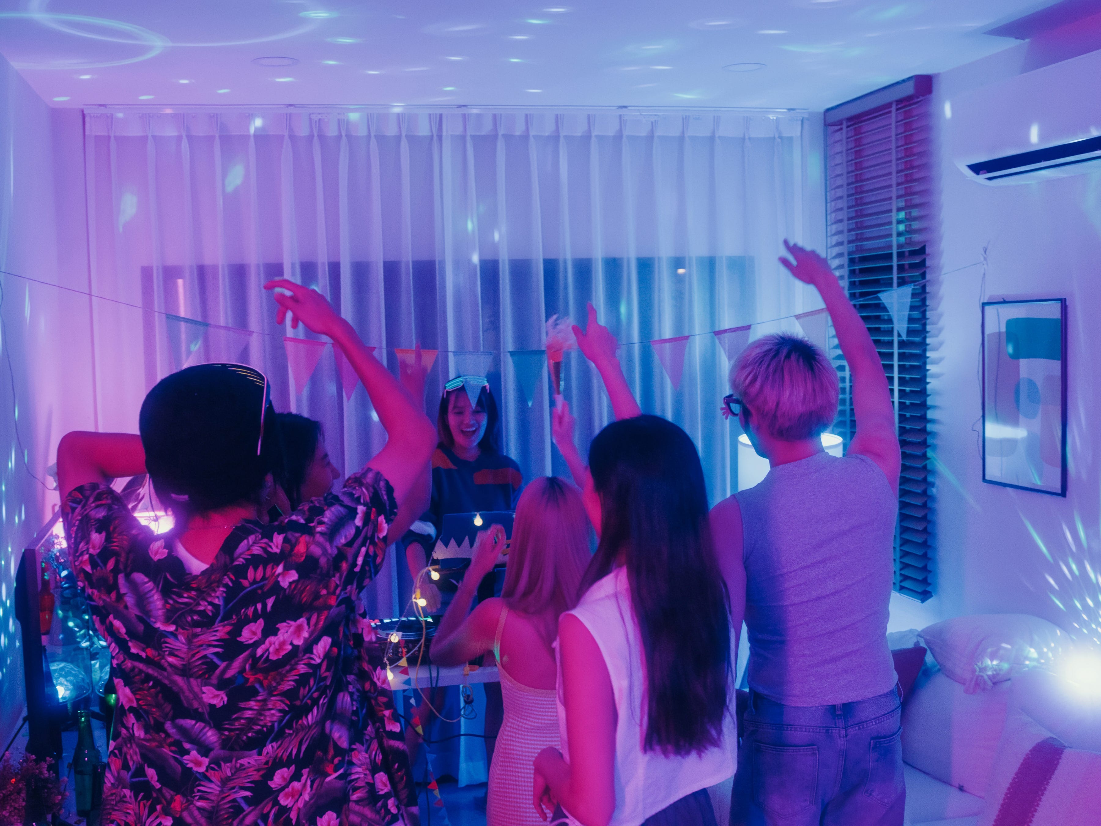 Teens dance at a house party.