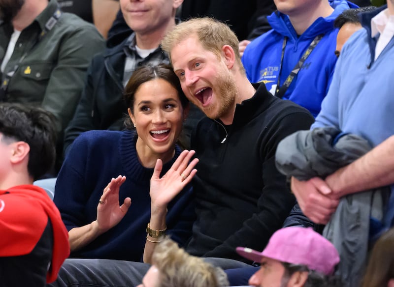 Prince Harry and Meghan at a basketball game.