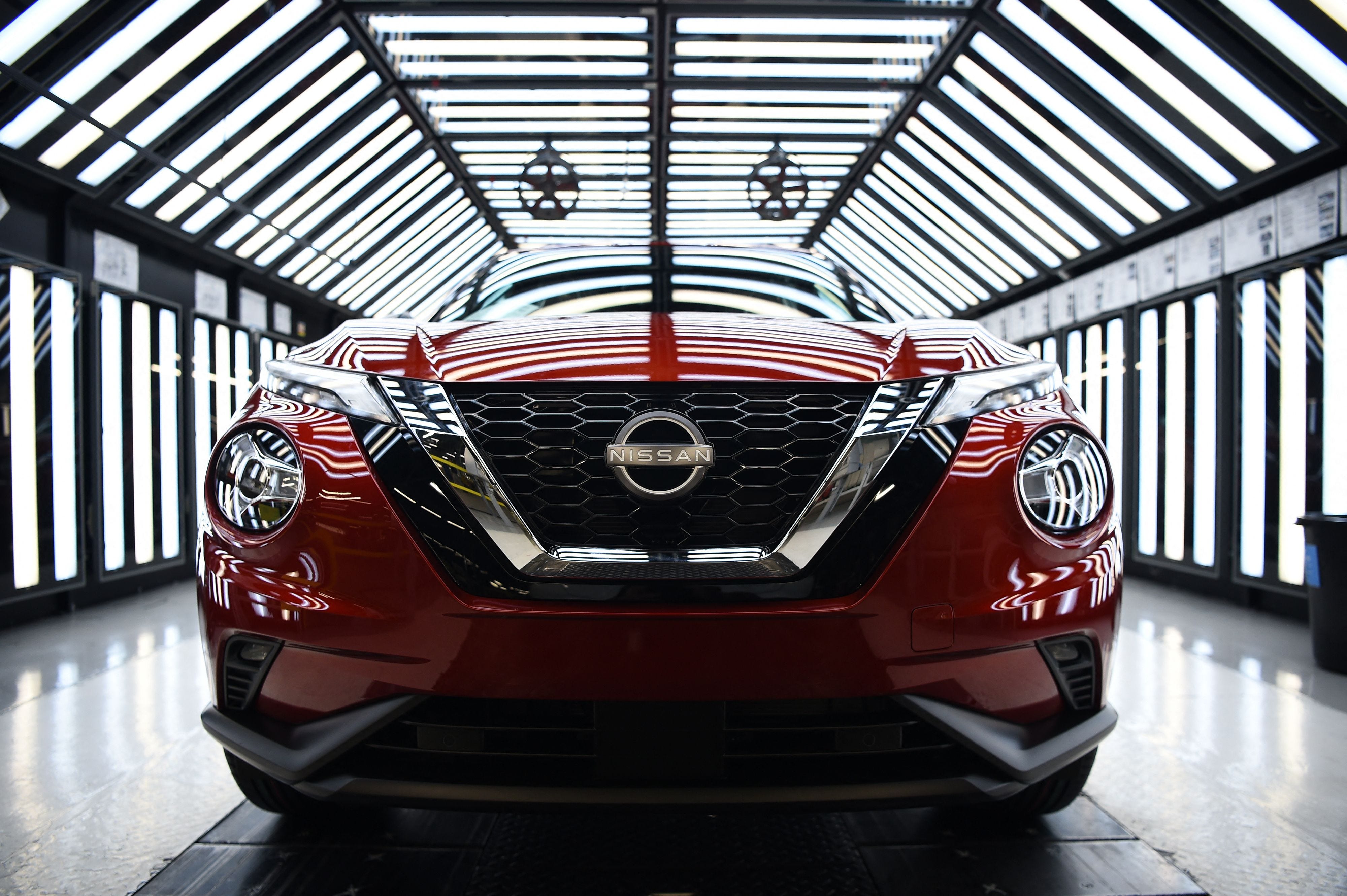 A red Nissan Juke car is seen on a production line.
