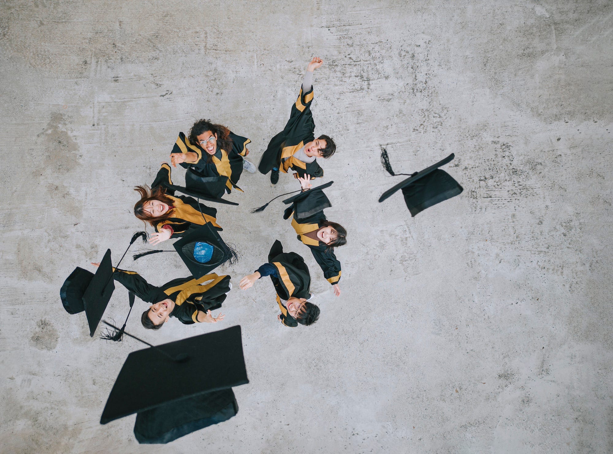 People tossing graduation caps