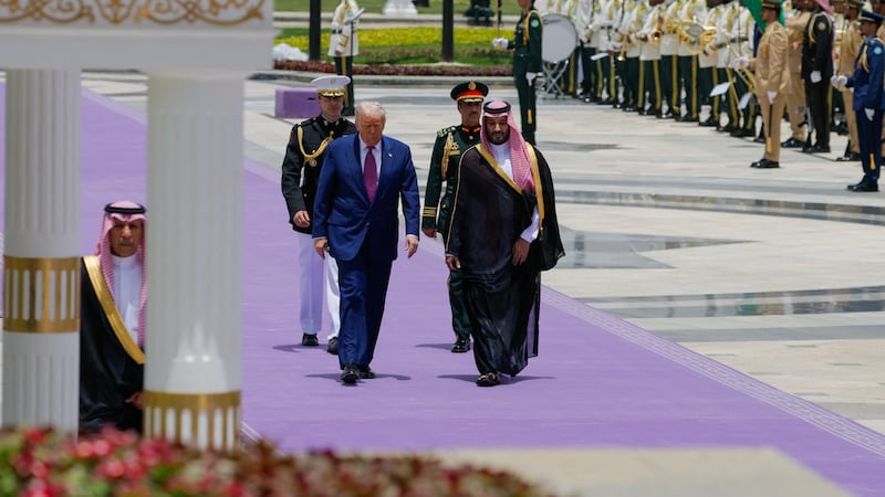 Donald Trump and Saudi Crown Prince Mohammed Bin Salman walk as they meet in Riyadh, Saudi Arabia