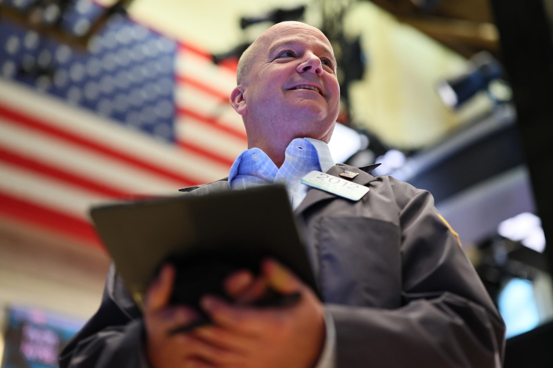 A trader in front of an American flag