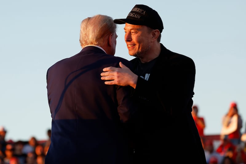 Elon Musk embraces Donald Trump during a campaign rally on October 05, 2024 in Butler, Pennsylvania.