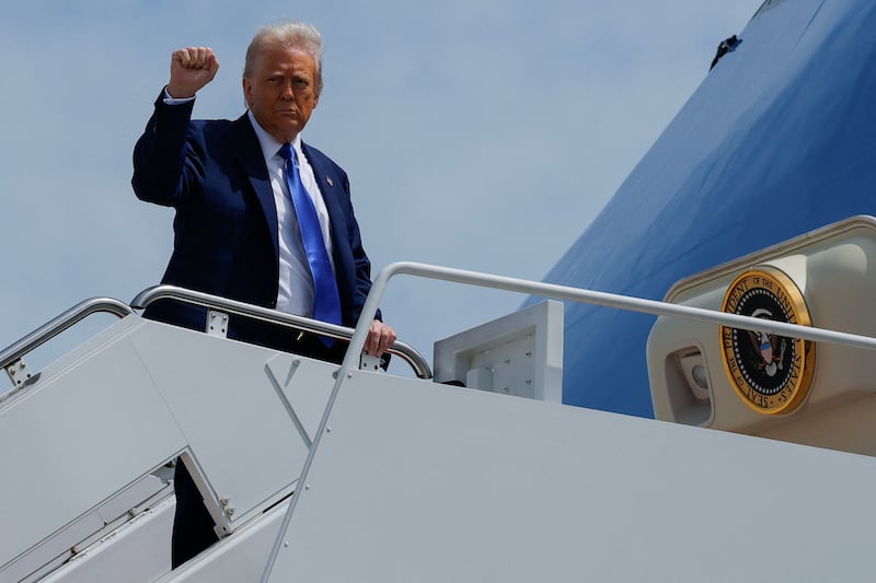 U.S. President Donald Trump gestures, while he boards Air Force One, as he departs for Saudi Arabia, Qatar and the United Arab Emirates, at Joint Base Andrews, in Maryland, U.S. May 12, 2025. REUTERS/Brian Snyder