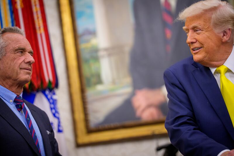 President Donald Trump looks at Health and Human Services Secretary Robert F. Kennedy Jr. while speaking in the Oval Office at the White House on April 18, 2025 in Washington, D.C.