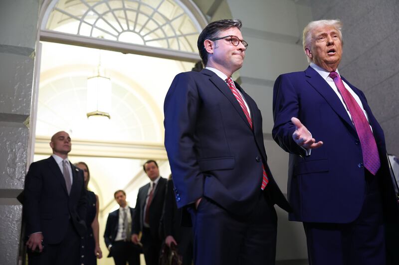 House Speaker Mike Johnson stands with President Donald Trump as he speaks to reporters ahead of a closed-door meeting with House Republicans on May 20, 2025 on Capitol Hill in Washington, D.C.
