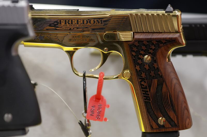 A gun engraved with the word "FREEDOM" is displayed during the National Rifle Association (NRA) Annual Meeting & Exhibits at the Kay Bailey Hutchison Convention Center on May 17, 2024 in Dallas, Texas.