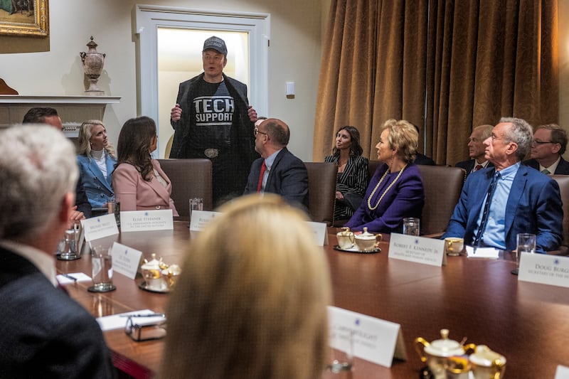 Elon Musk wears a shirt that says