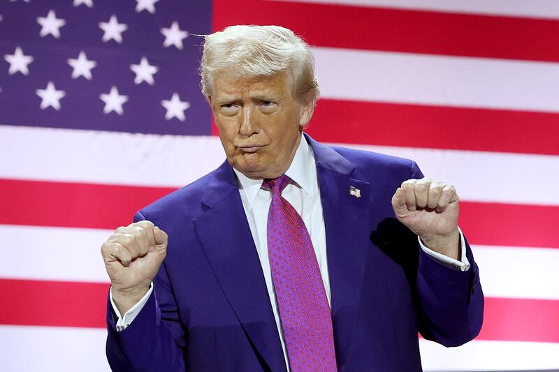 President Donald Trump gestures on stage as he tours the Al Udeid Air Base on May 15, 2025, in Doha, Qatar.