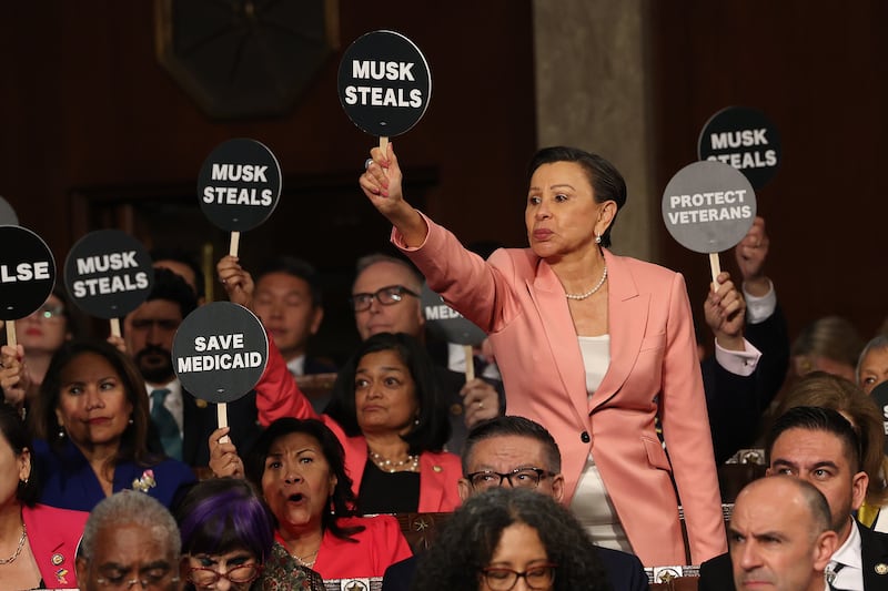 Rep. Nydia Velázquez (D-NY) and fellow Democrats wave as President Donald Trump address a joint session of Congress at the U.S. Capitol on March 4, 2025 in Washington, D.C.