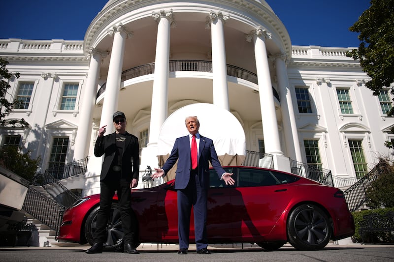 Elon Musk and Donald Trump in front of White House with Tesla.