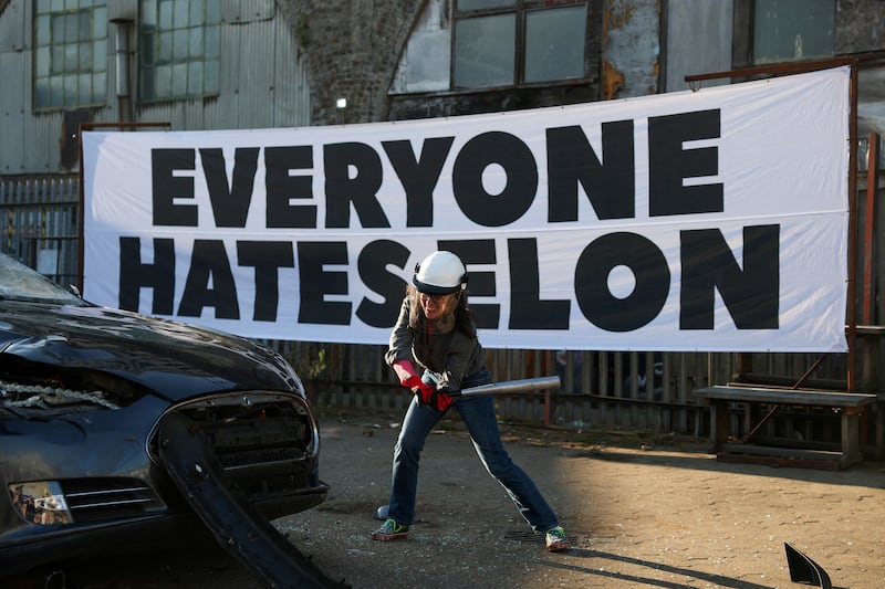FILE PHOTO: A person smashes a Tesla car, donated anonymously and destined for scrap during a stunt organised by the group Everyone Hates Elon, part of a campaign against Tesla CEO Elon Musk’s political involvement in the U.S. government, in London, Britain, April 10, 2025. REUTERS/Hannah McKay/File Photo