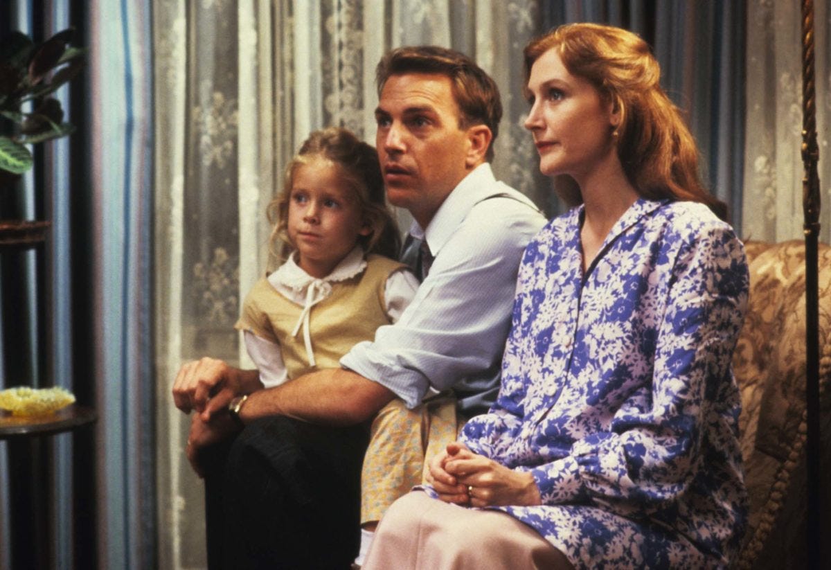 Patricia Clarkson and Kevin Costner sitting next to each other