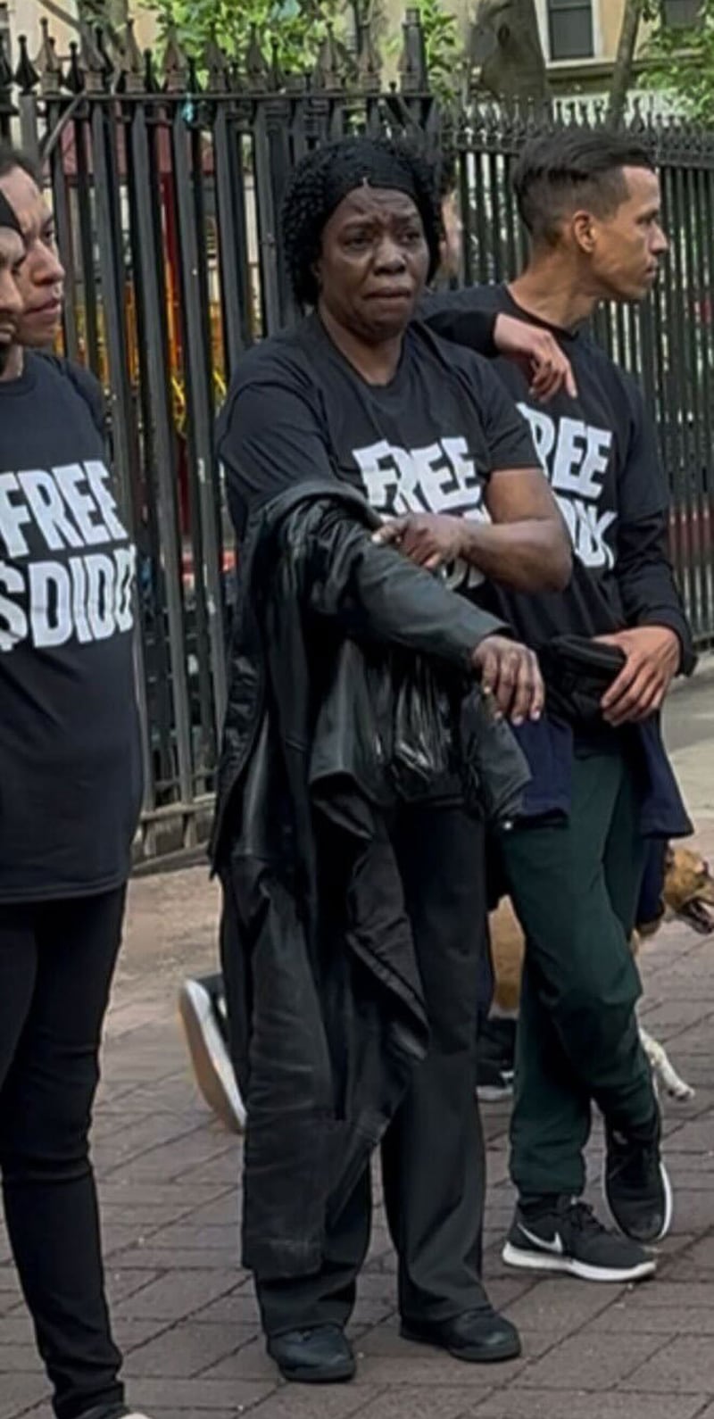 People wearing "Free $Diddy" shirts outside court in New York City