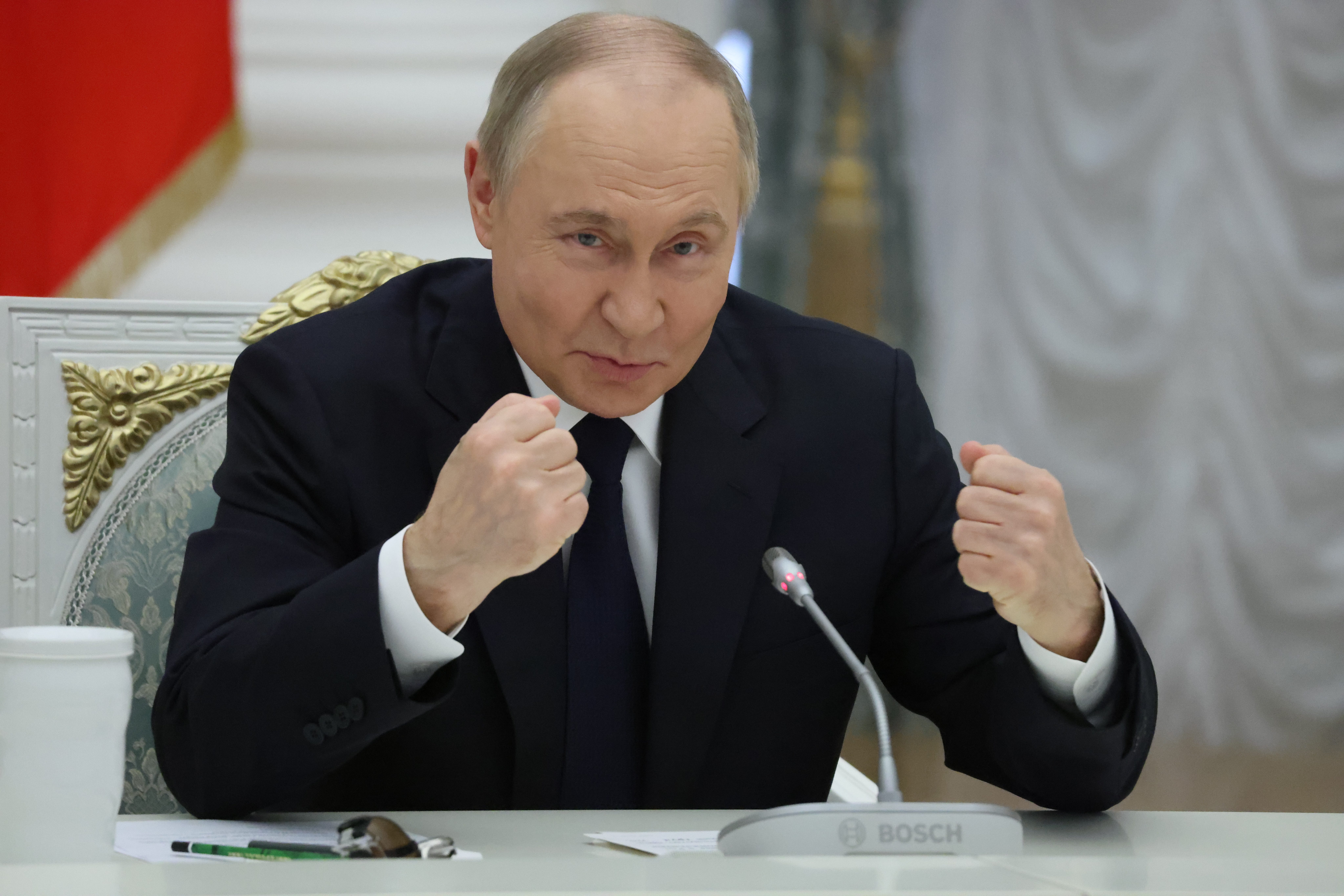 Russian leader Vladimir Putin gestures during his meeting with local business leaders at the Saint Yekeaterina's Hall of the Kremlin.